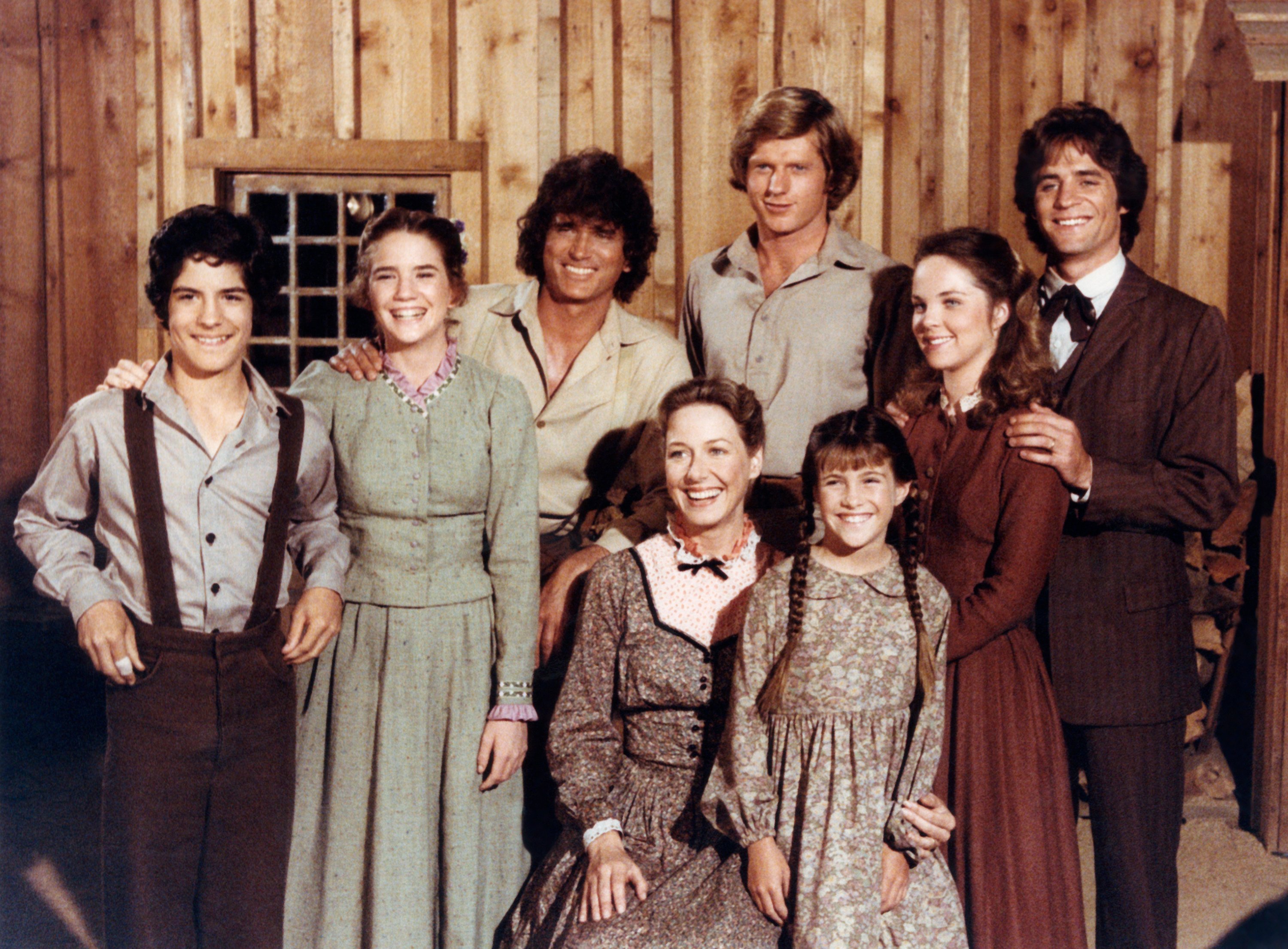 Little House on the Prairie cast posing together and smiling
