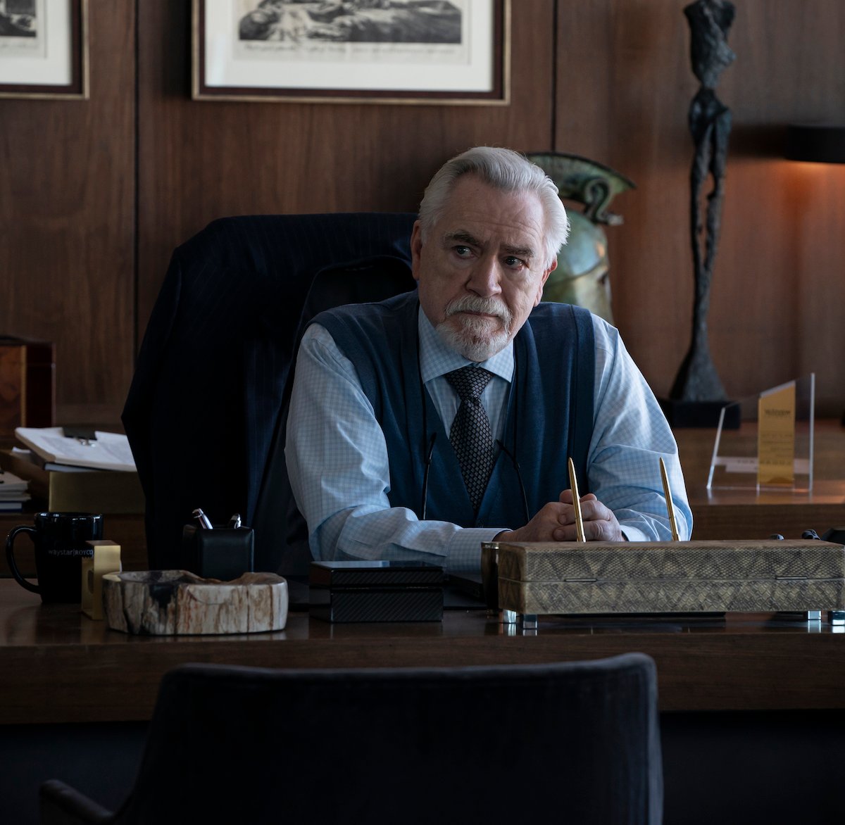 'Succession' cast member Brian Cox sits at Logan Roy's desk with his hands folded