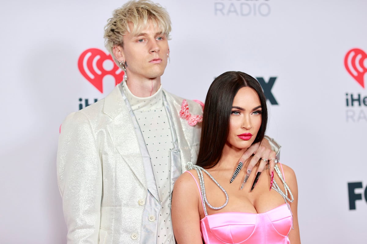 Machine Gun Kelly and Megan Fox pose together at an event.