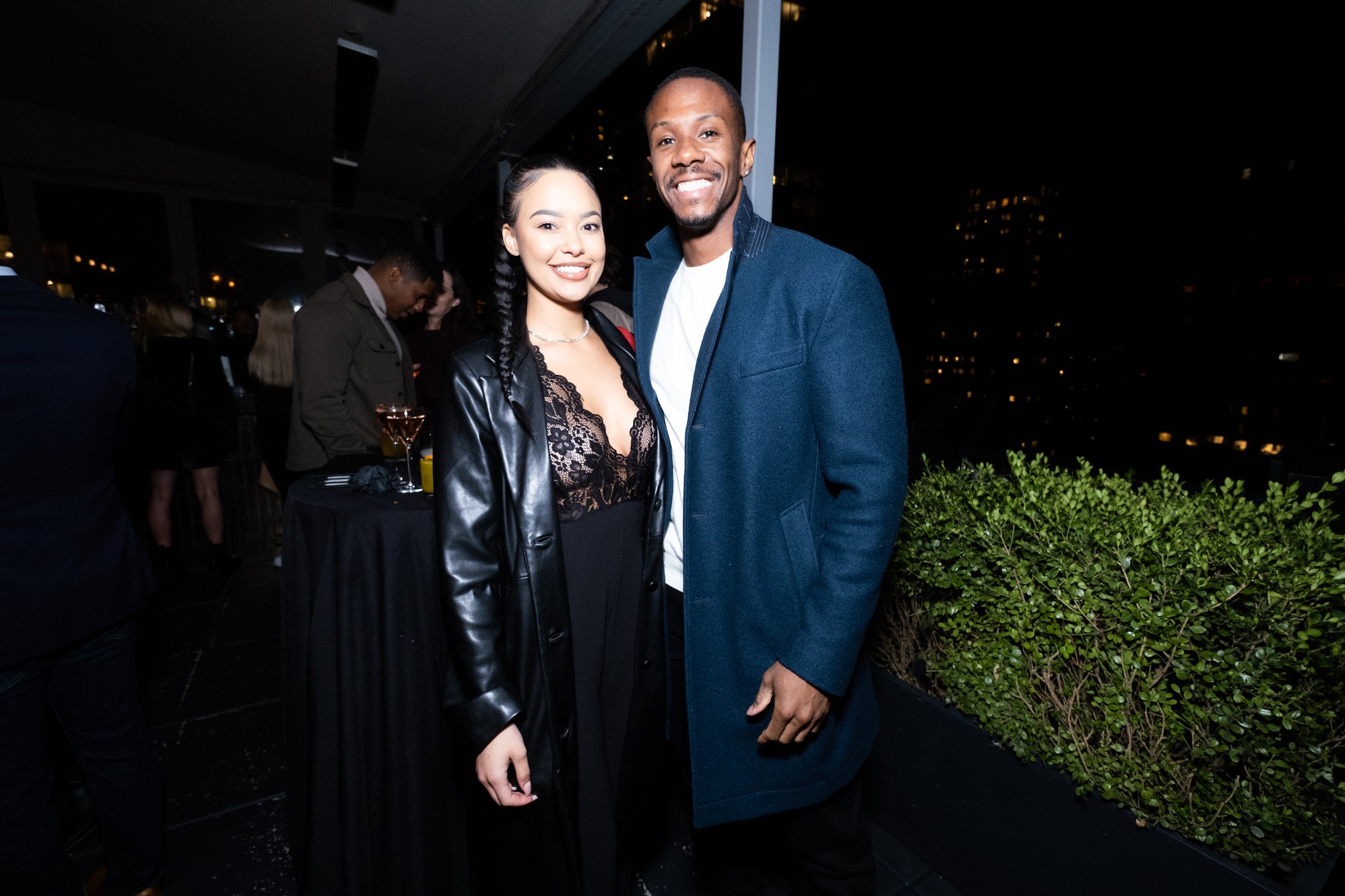 Riley Christian and Maurissa Gunn from 'Bachelor in Paradise' standing together and smiling at night