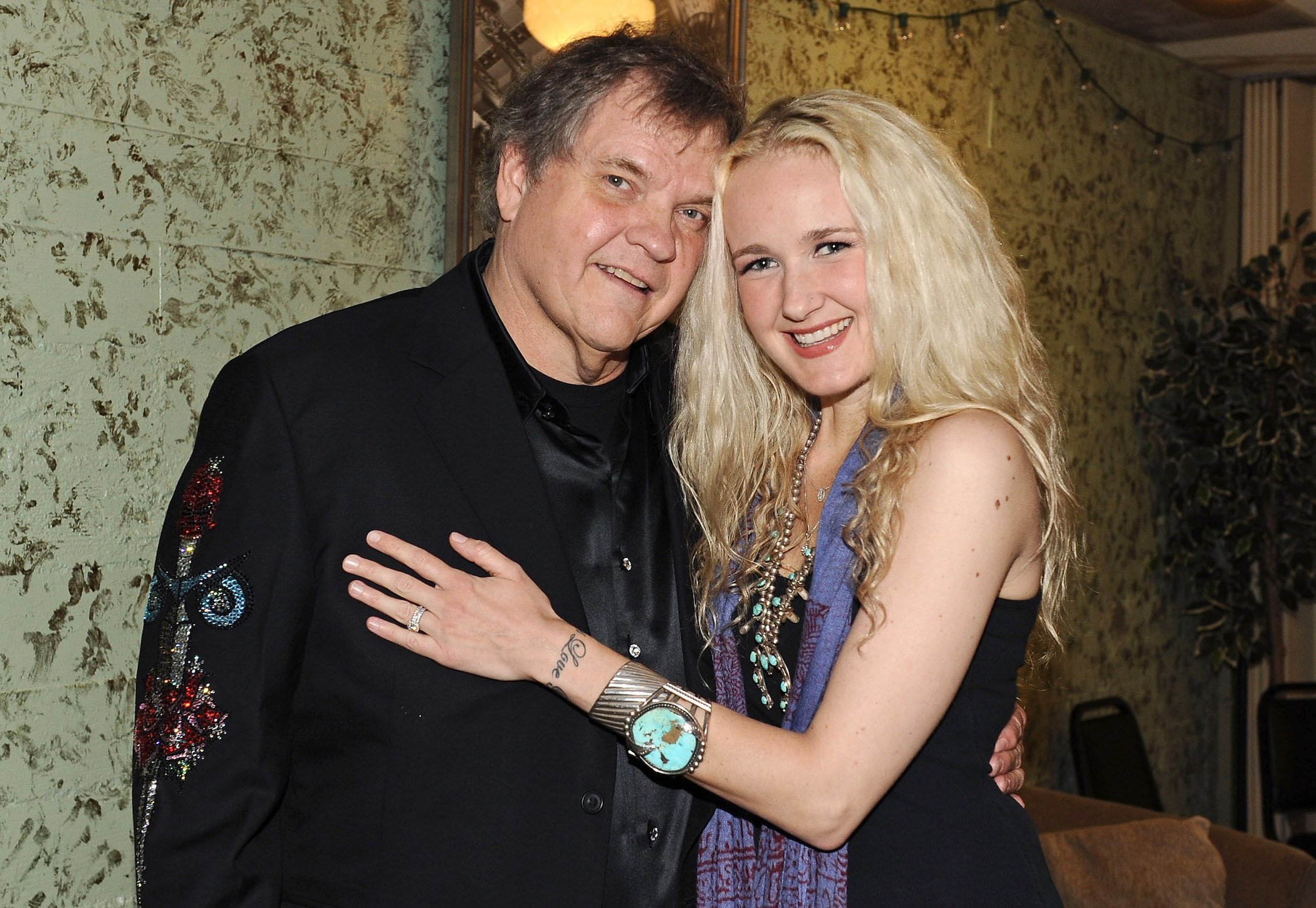 Meat Loaf and his daughter Pearl Aday standing together and smiling backstage