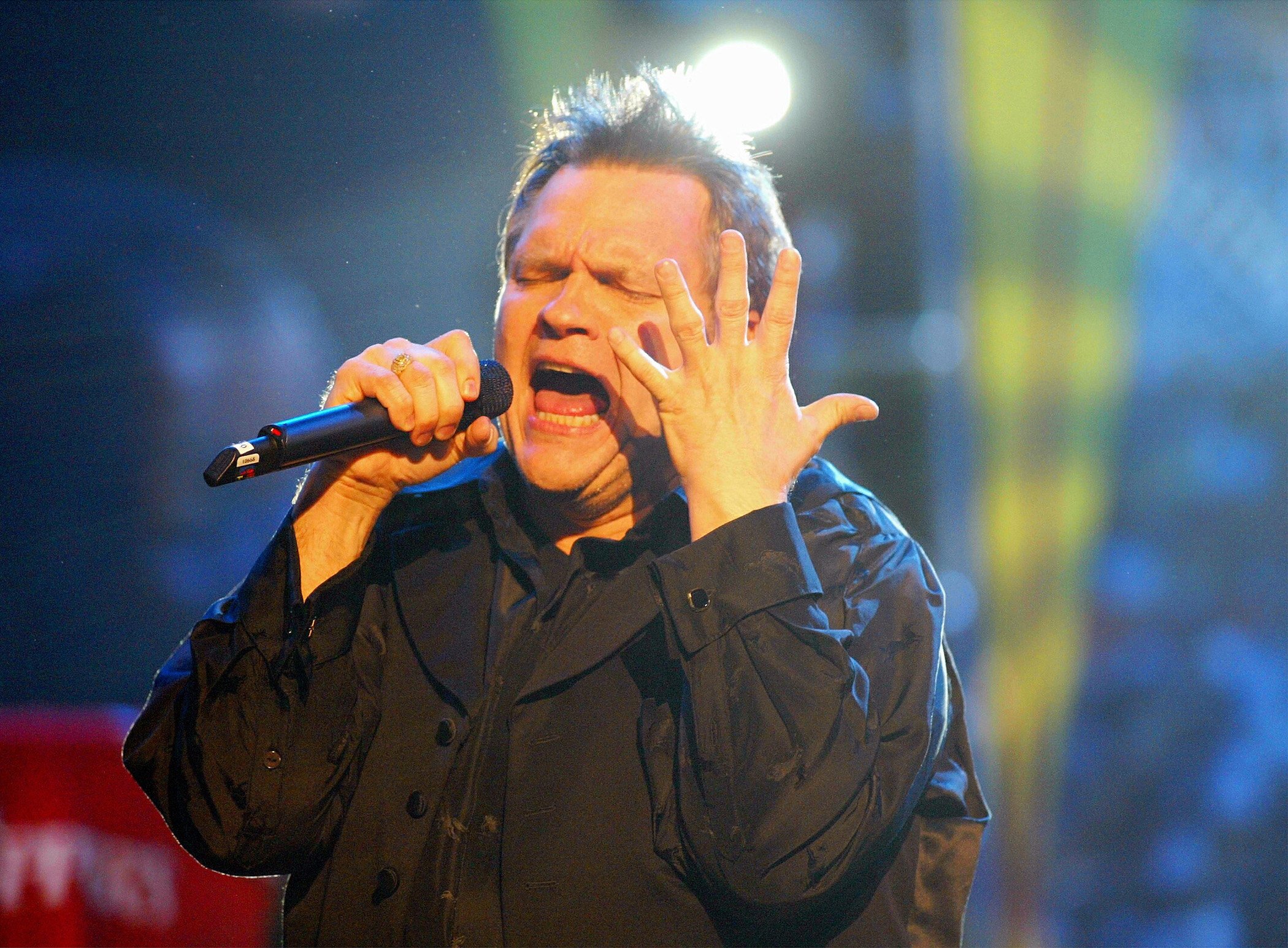 Meat Loaf passionately singing on stage