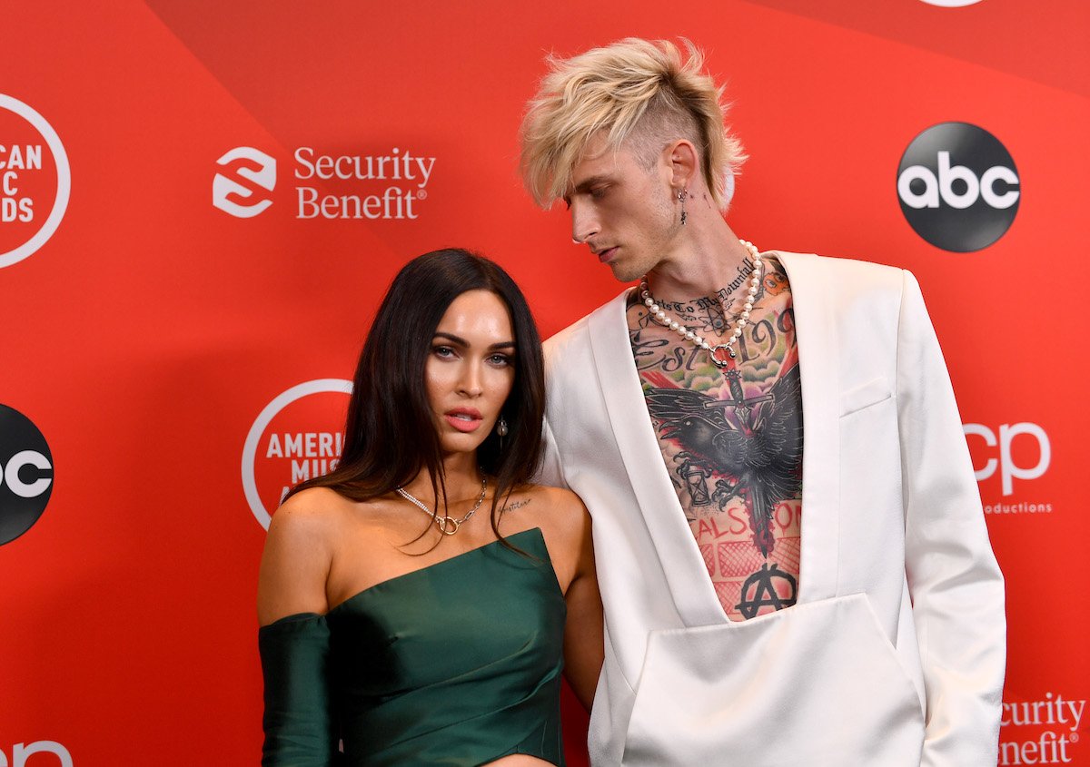 Megan Fox and Machine Gun Kelly pose together at an event.