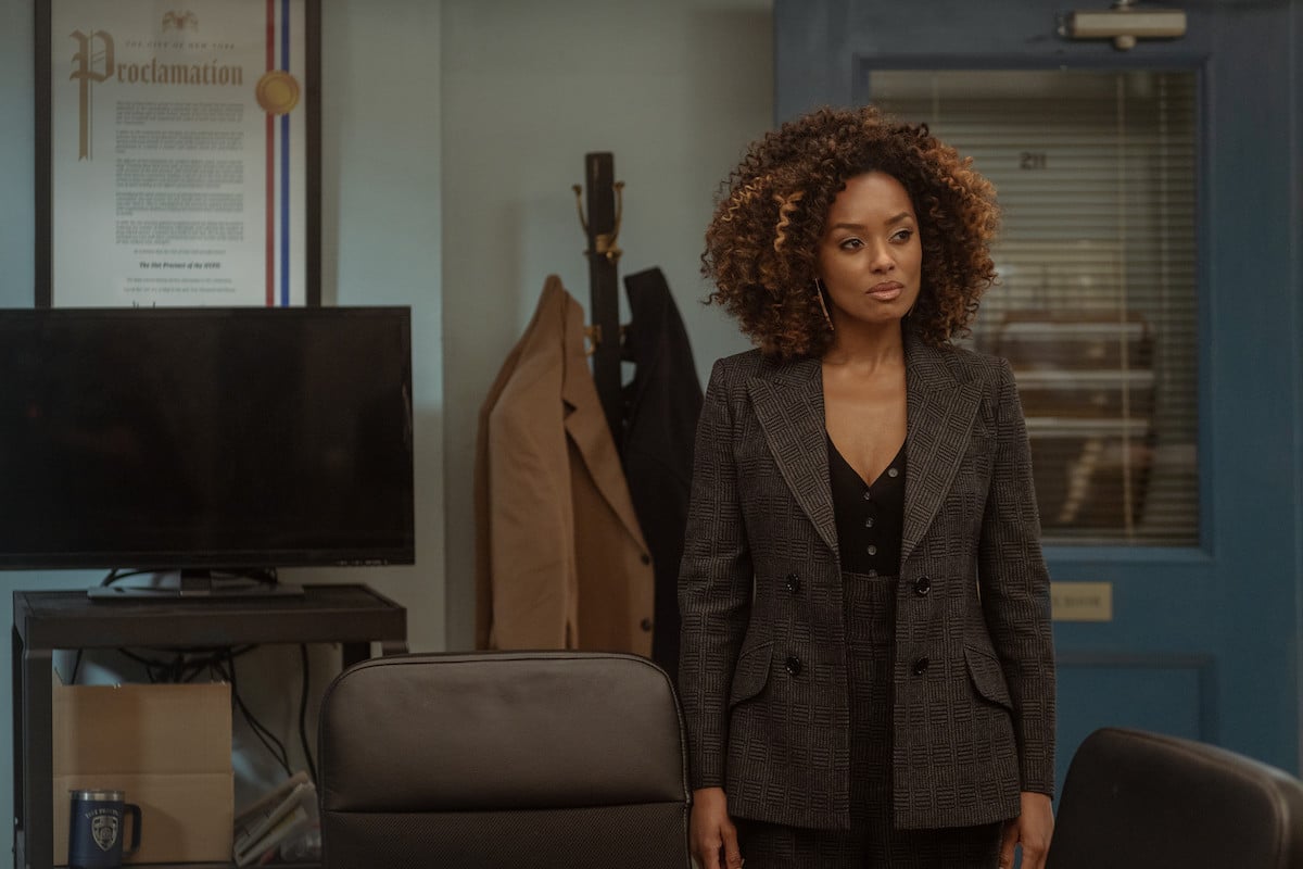 Melanie Linburd as Carrie Milgram wearing a brown blazer and standing in a office in 'Power Book II: Ghost'