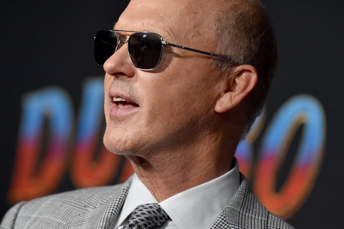 Michael Keaton wears sunglasses and a gray suit at the ‘Dumbo’ premiere