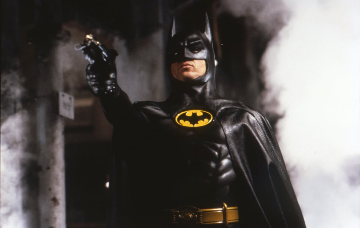 Michael Keaton as Batman wears his Batsuit and shoots a grappling gun in 'Batman'