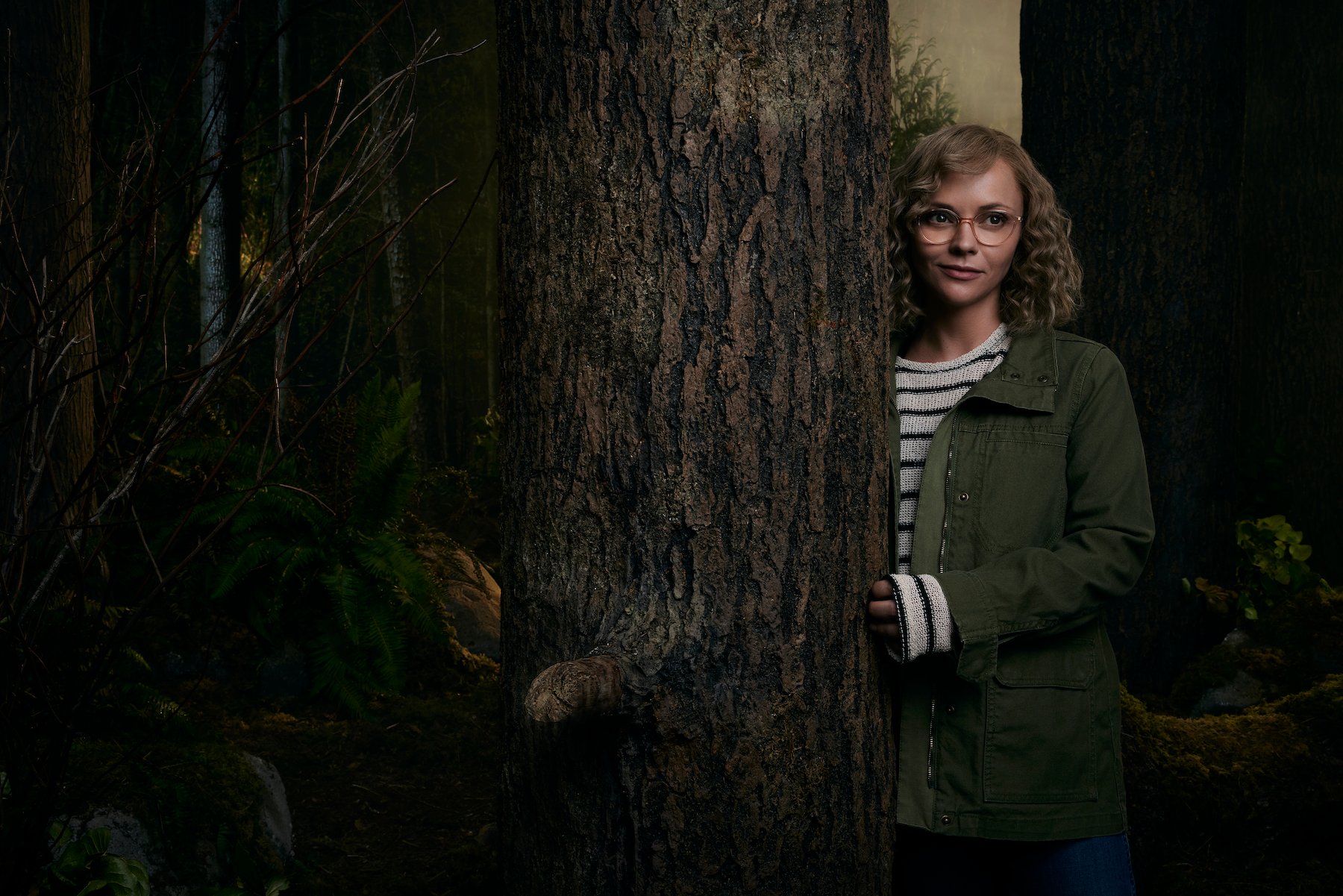 Christina Ricci as Misty in 'Yellowjackets' standing next to a tree outside