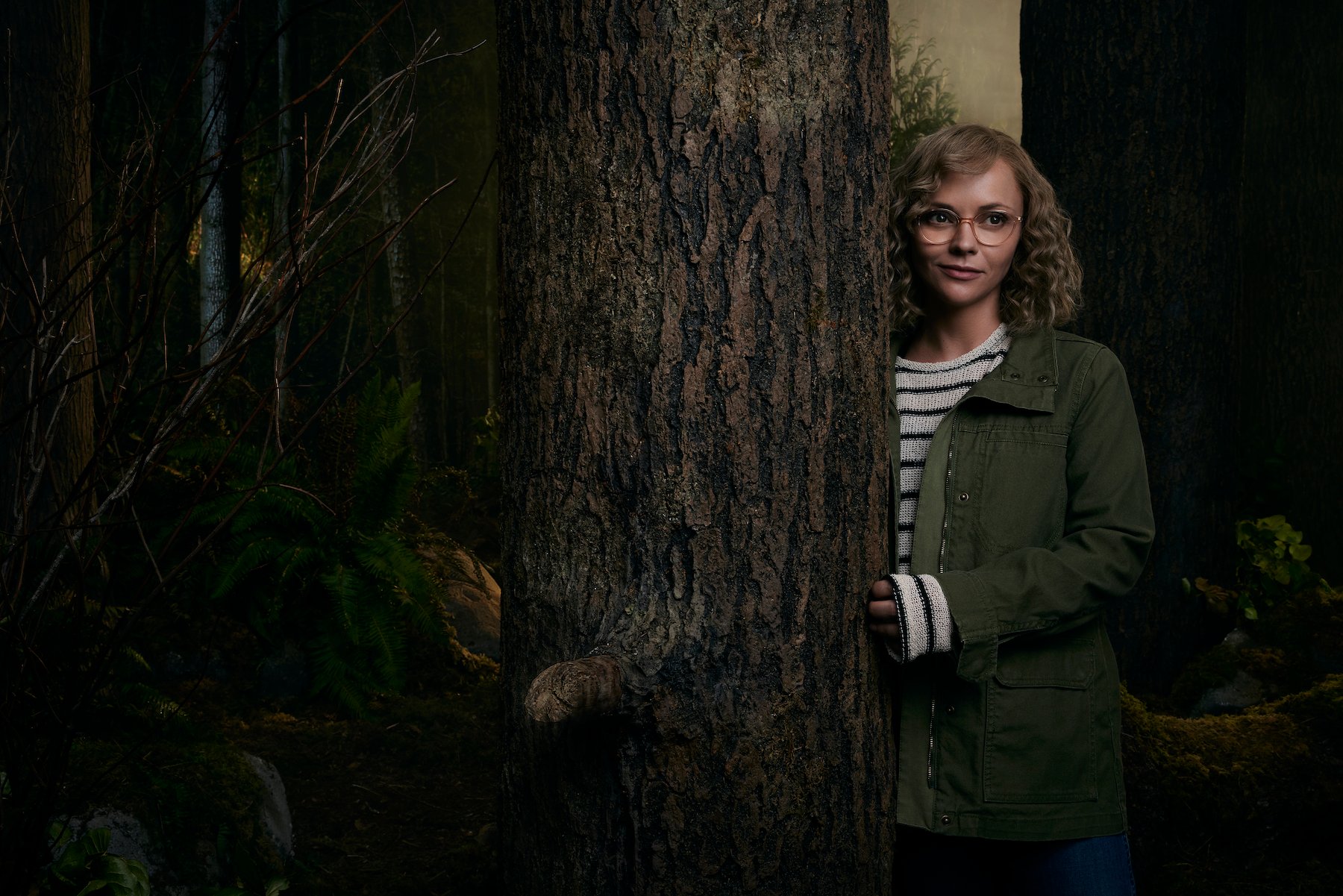 Christina Ricci as Misty in 'Yellowjackets'  standing next to a tree outside