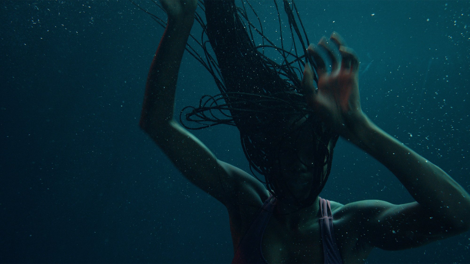 'Nanny' Anna Diop as Aisha underwater holding her hands up