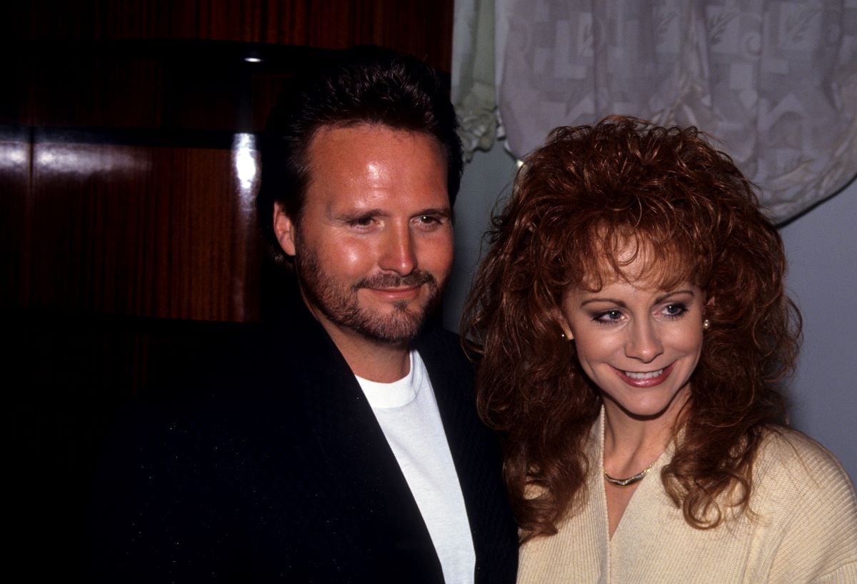 Narvel Blackstock in a black jacket and white shirt, with Reba McEntire in a sweater, in 1993