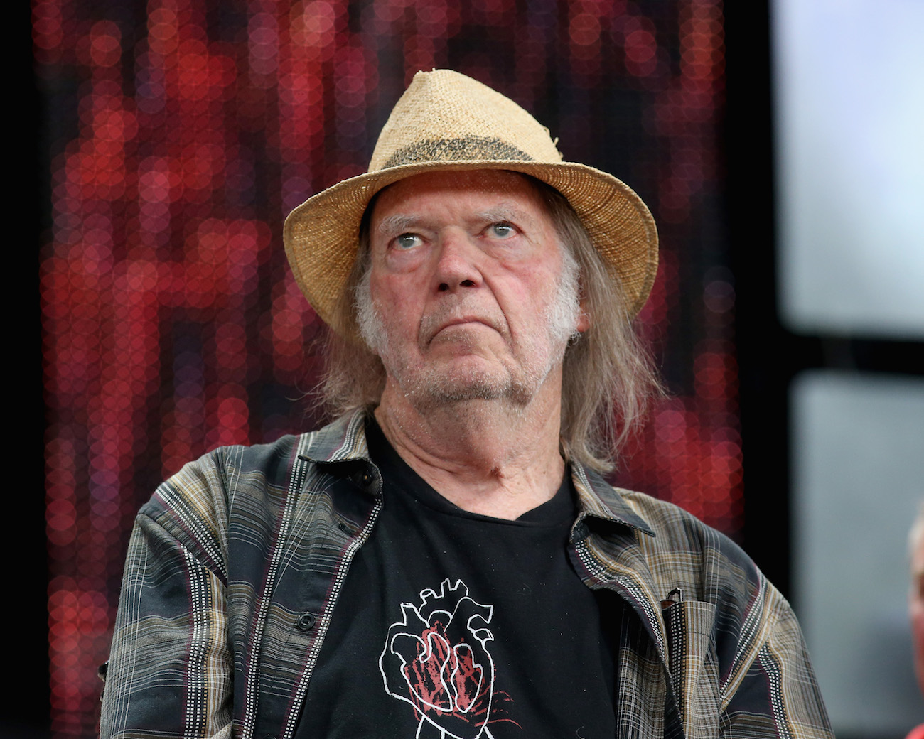 Neil Young in a flannel shirt at a press conference for Farm Aid 34 in Wisconsin, 2019.