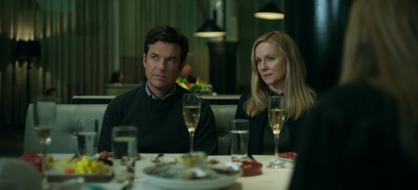 Jason Bateman as Martin 'Marty' Byrde and Laura Linney as Wendy Byrde sitting together at a dinner table in 'Ozark' Season 4 Part 1