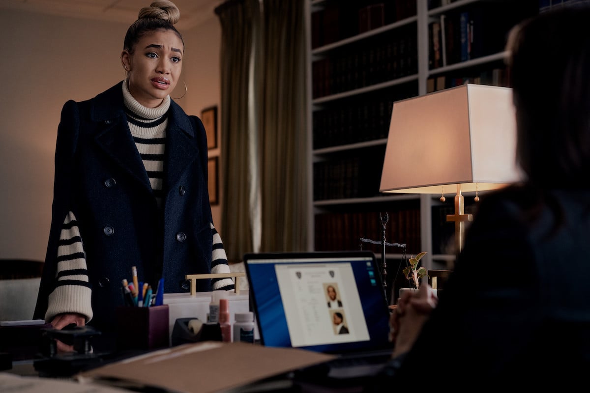 Paige Hurd and Lauren Baldwin looking concerned why wearing a striped turtleneck and a black coat in 'Power Book II: Ghost'