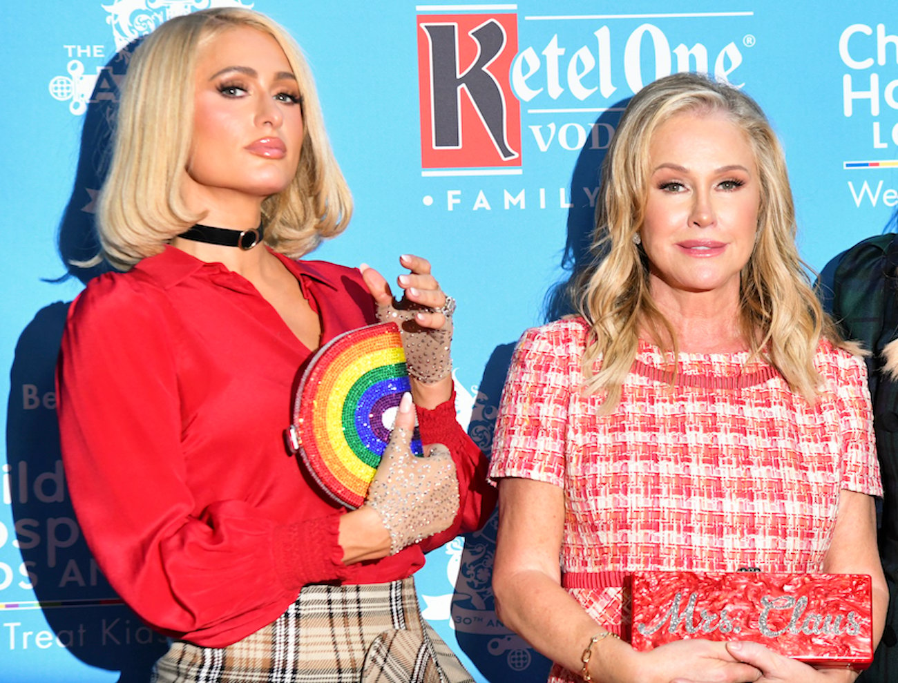 Paris Hilton and Kathy Hilton wear red as they pose for cameras