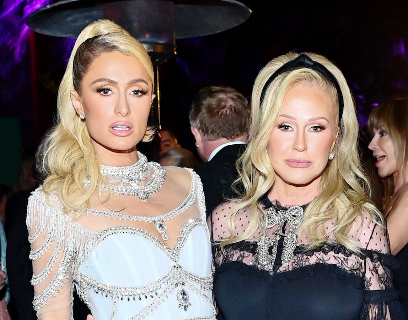 Paris Hilton and Kathy Hilton pose together wearing white and black gowns