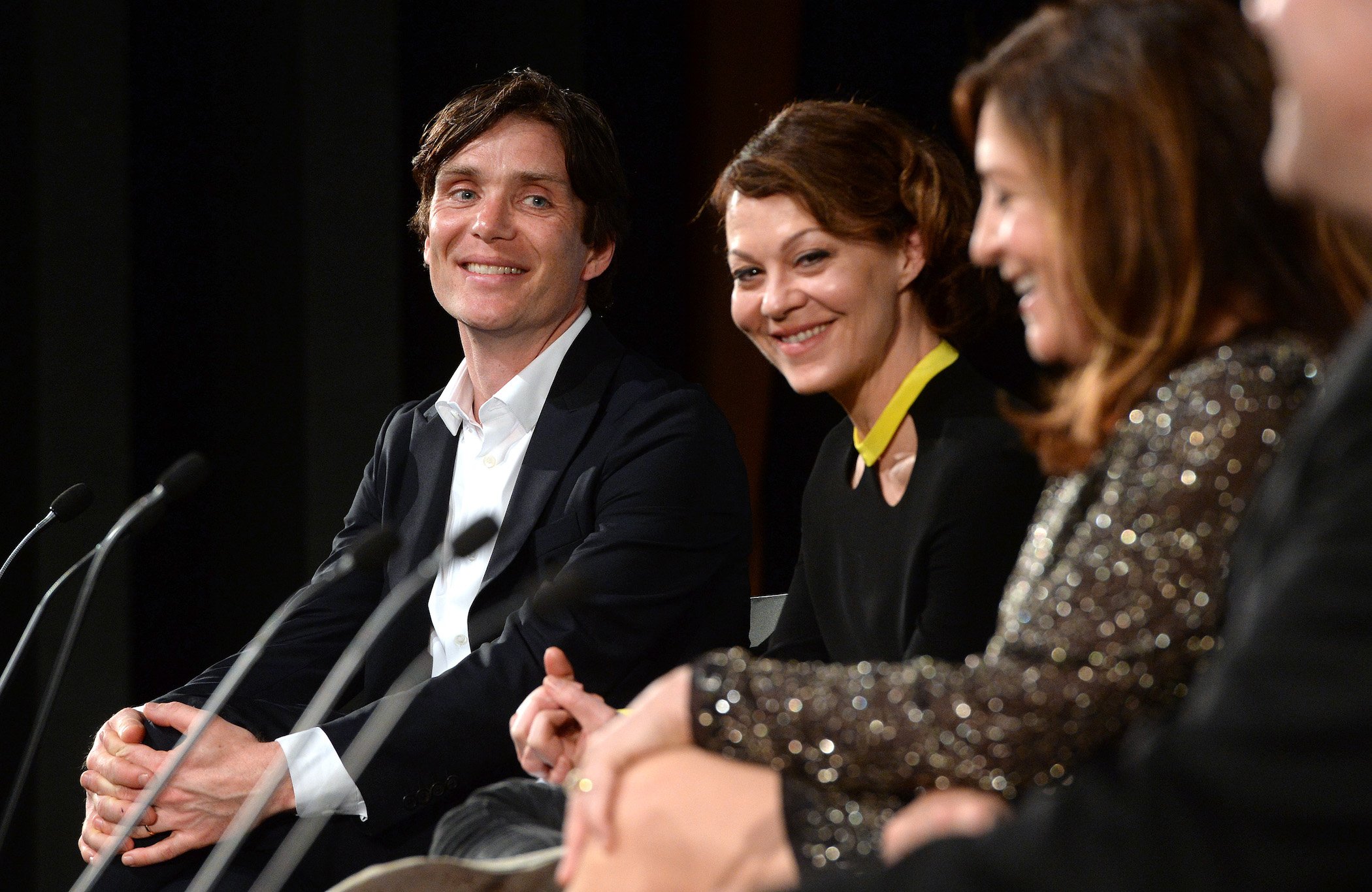 Cillian Murphy from 'Peaky Blinders' Season 6 and Helen McCrory smiling against a black background during a Q&A