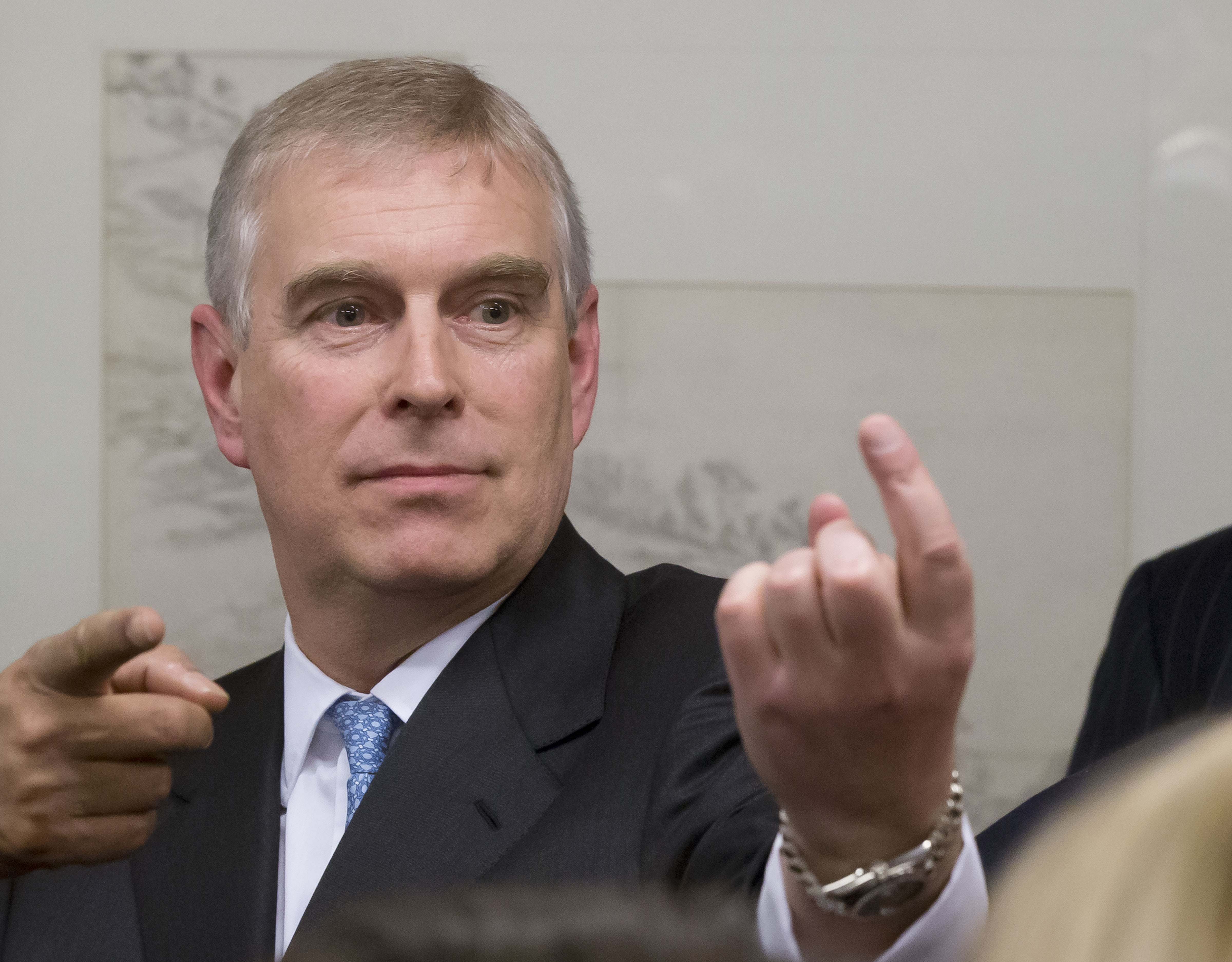 Prince Andrew gestures as he speaks with business leaders during a reception