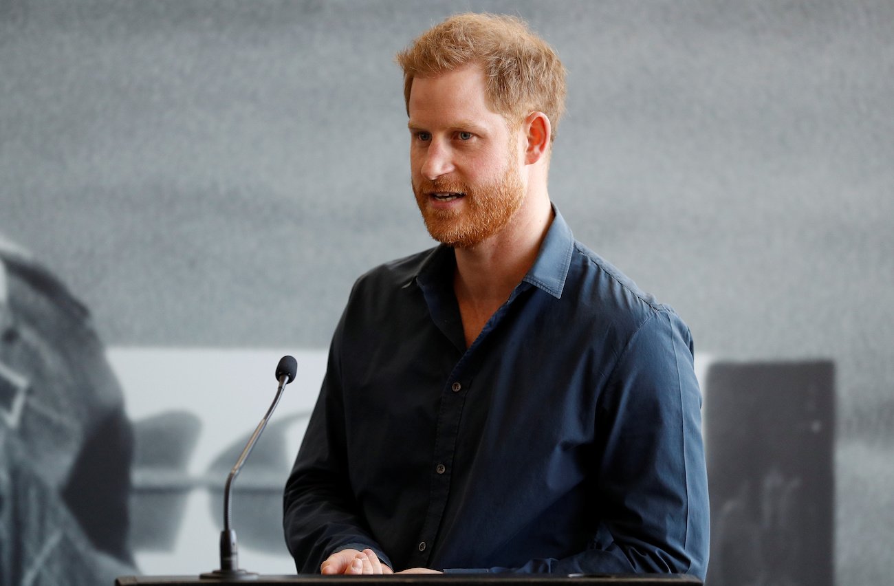 Prince Harry speaking behind a microphone