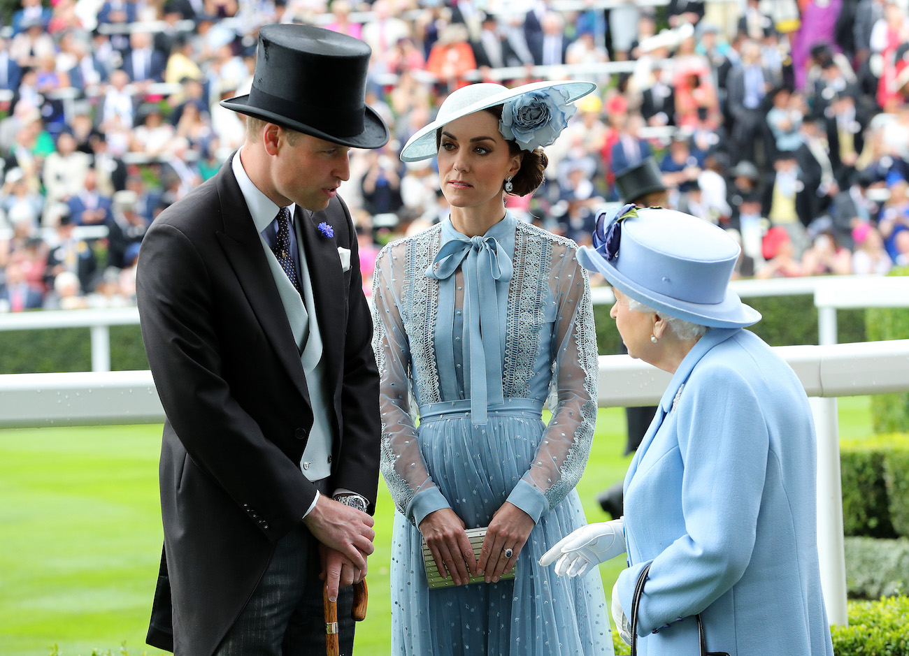 Kate Middleton looks at Prince William as he speaks to Queen Elizabeth II