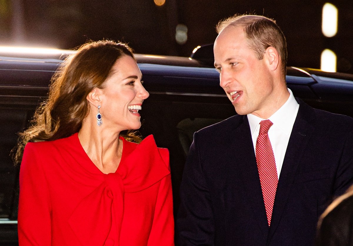 Prince William and Kate Middleton smiling as they arrive at a Christmas community carol service