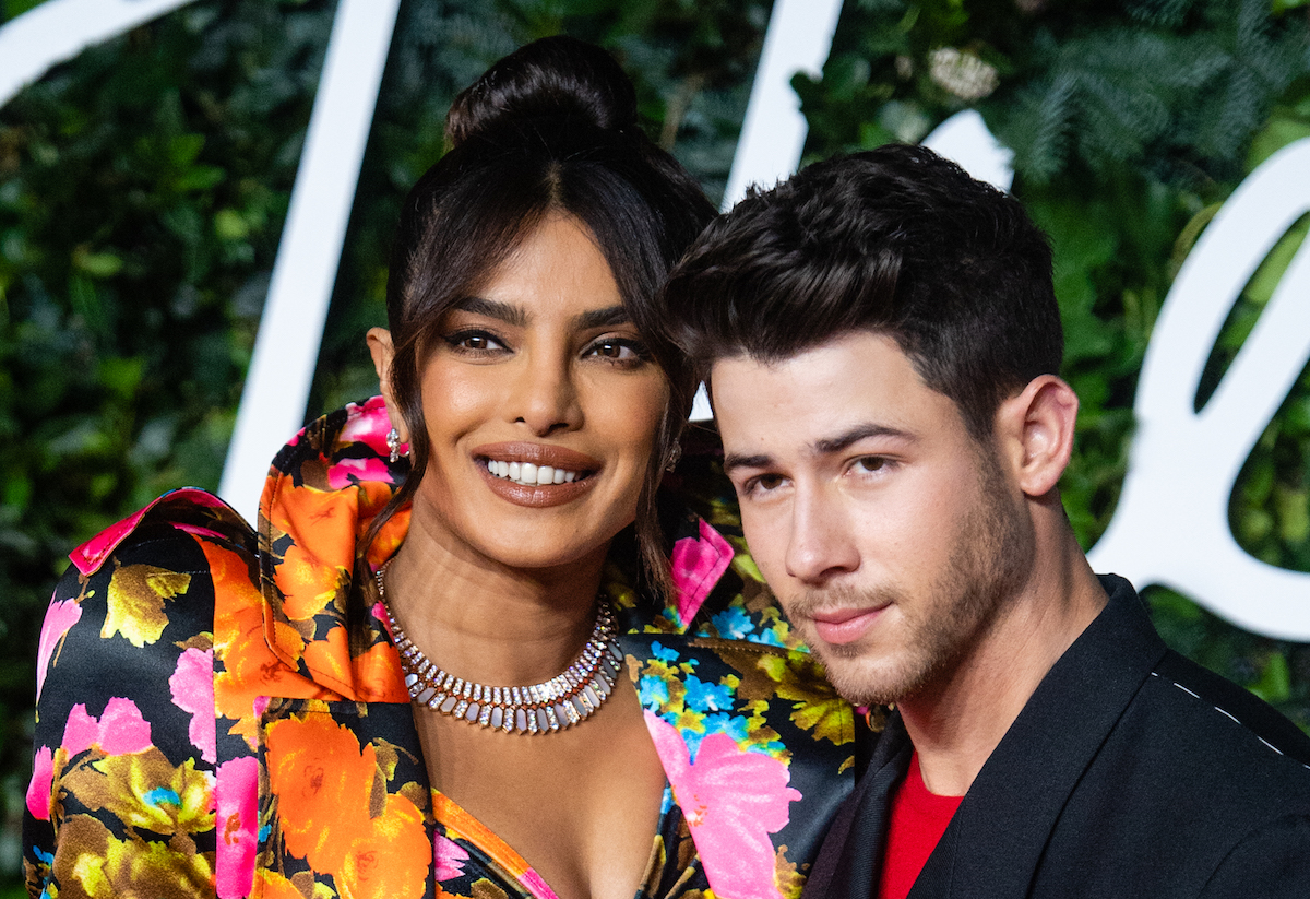 Priyanka Chopra and Nick Jonas smile together at an event.