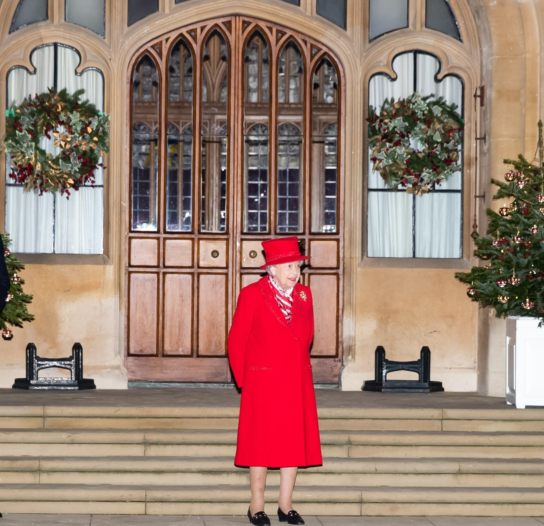Queen Elizabeth II standing in front of Windsor Castle