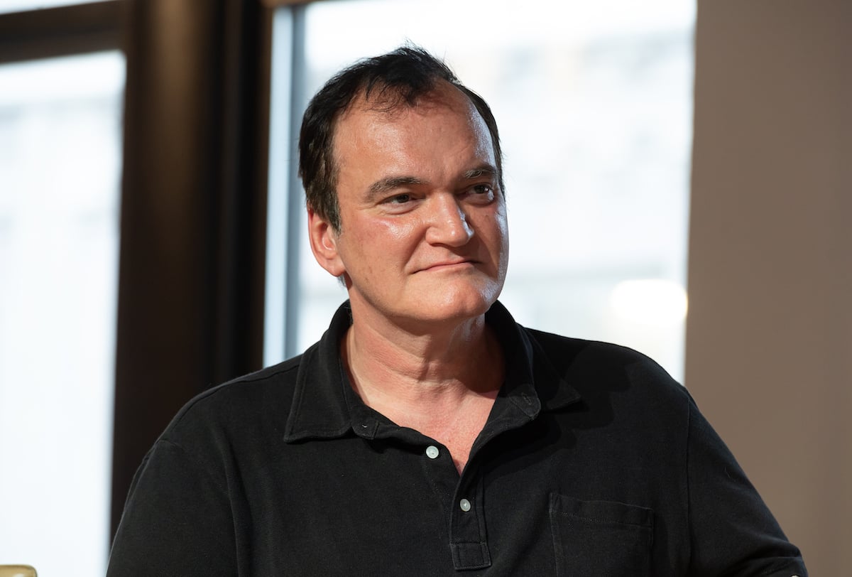 movie maker Quentin Tarantino wears a black collared shirt