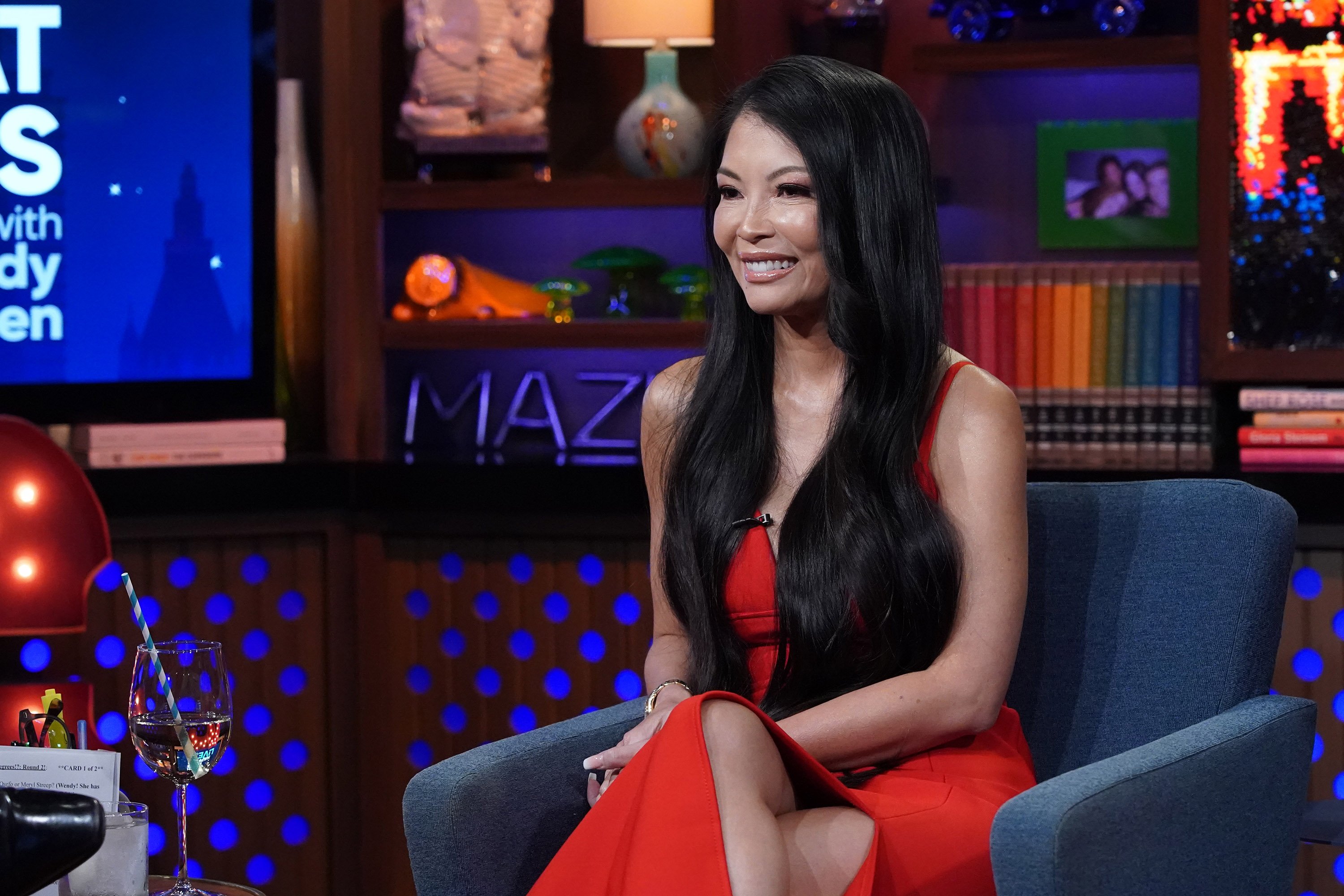 'RHOSLC' newcomer Jennie Nguyen sitting and smiling on set 'Watch What Happens Live With Andy Cohen' - Season 18
