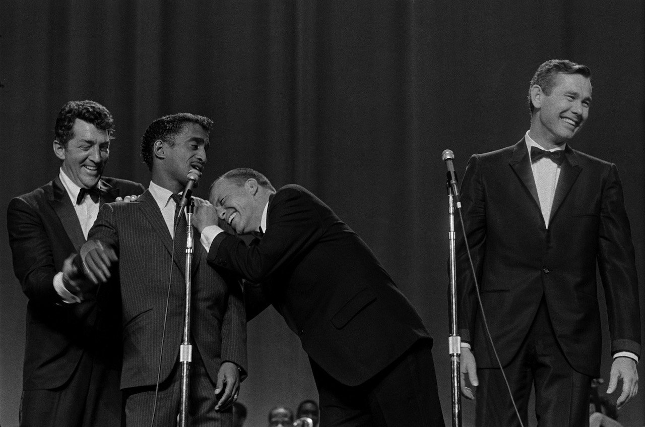 Dean Martin, Sammy Davis, Jr., Frank Sinatra and Johnny Carson perform on stage in 1969