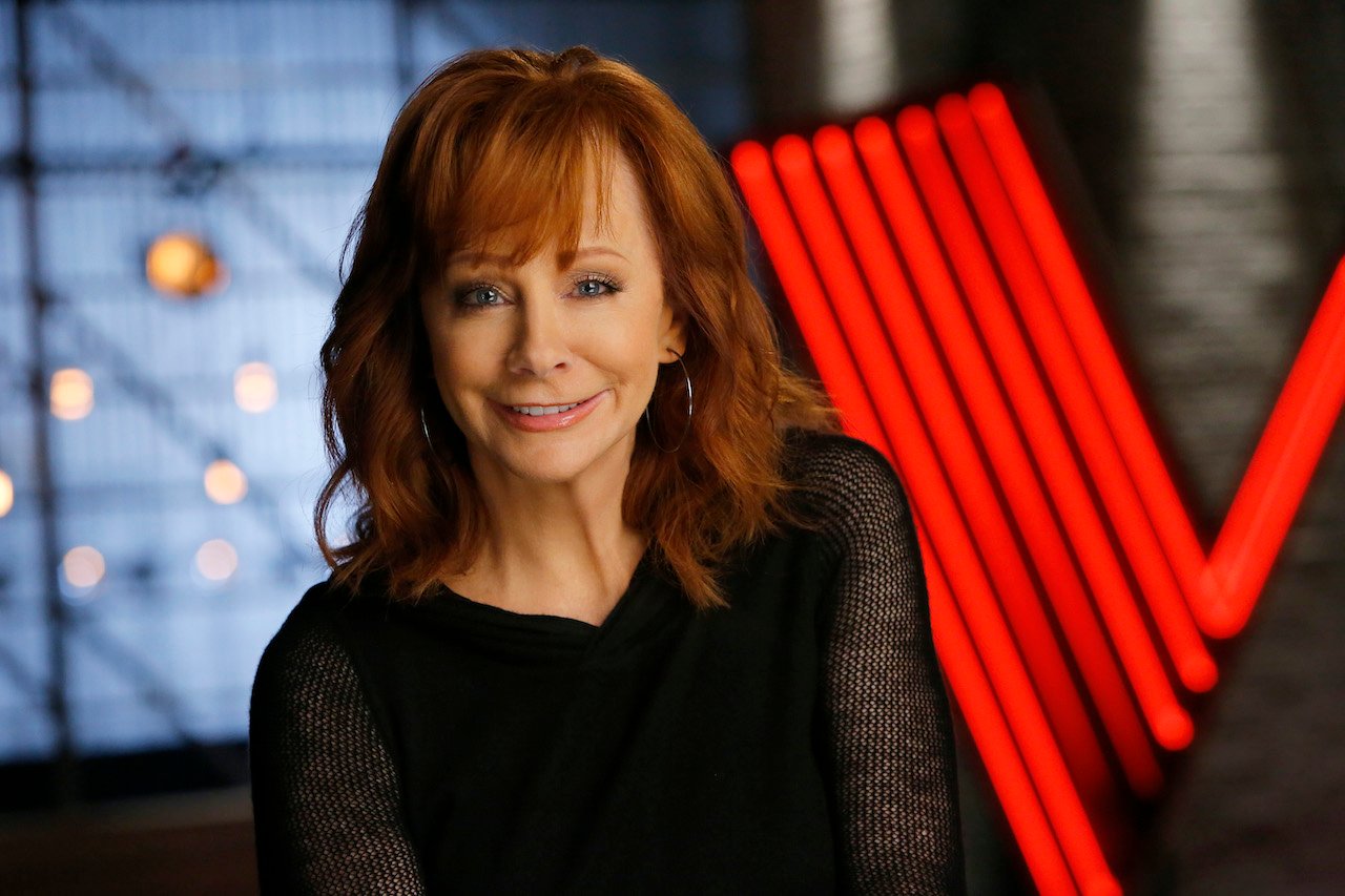 Reba McEntire smiles in a black sweater