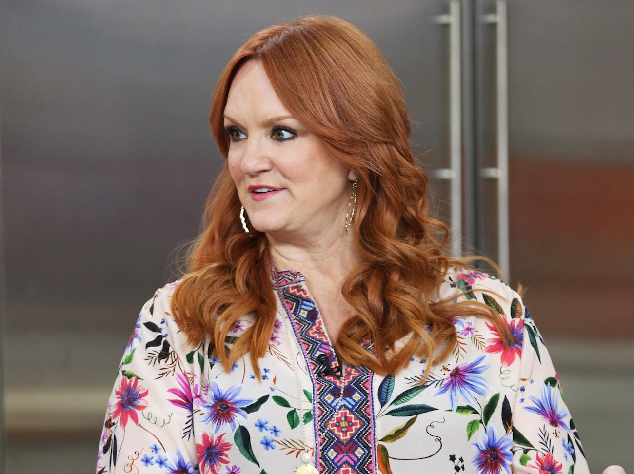 Ree Drummond looks on wearing a printed top