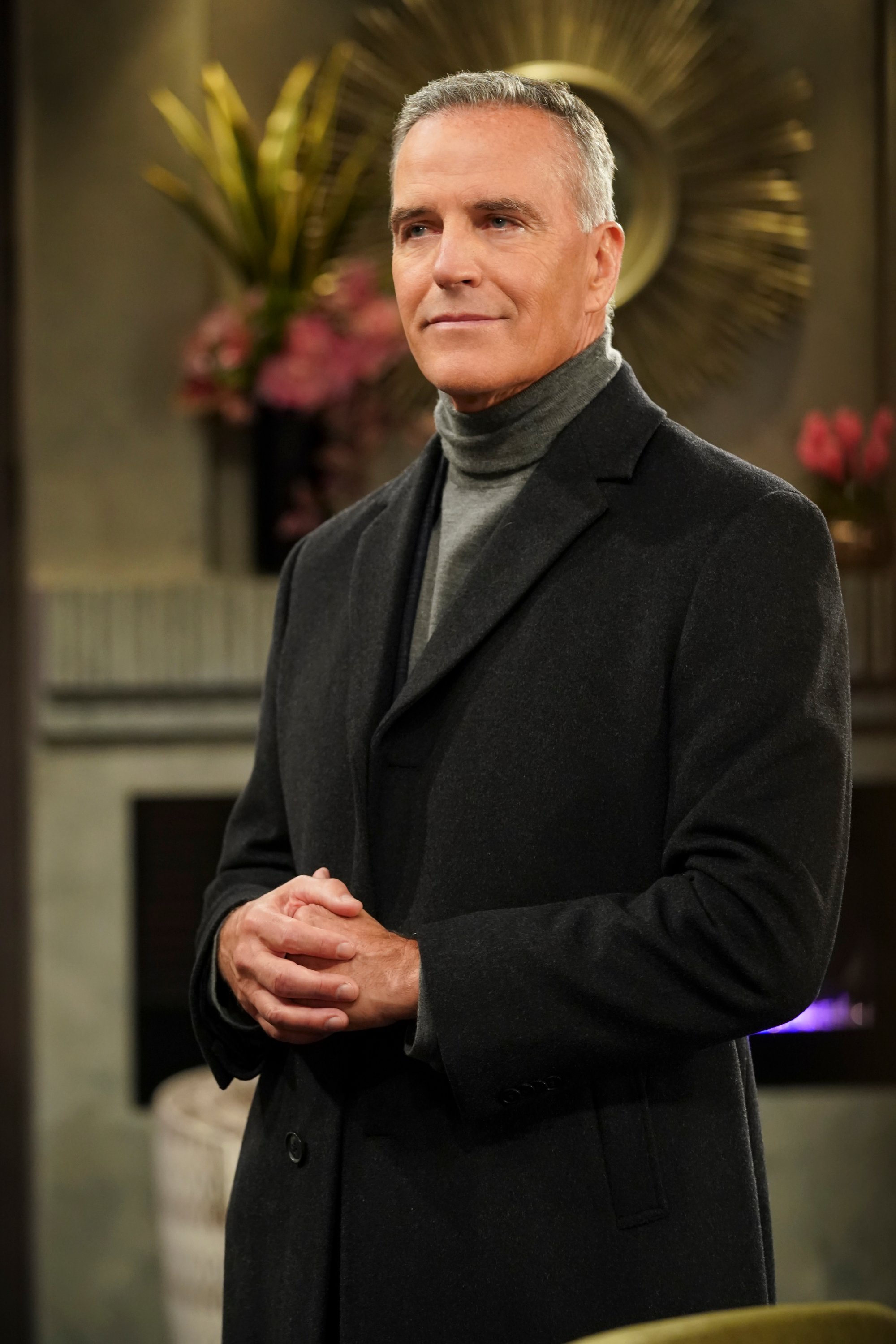 'The Young and the Restless' cast member Richard Burgi in a black suit and grey turtleneck on set of the CBS soap opera.