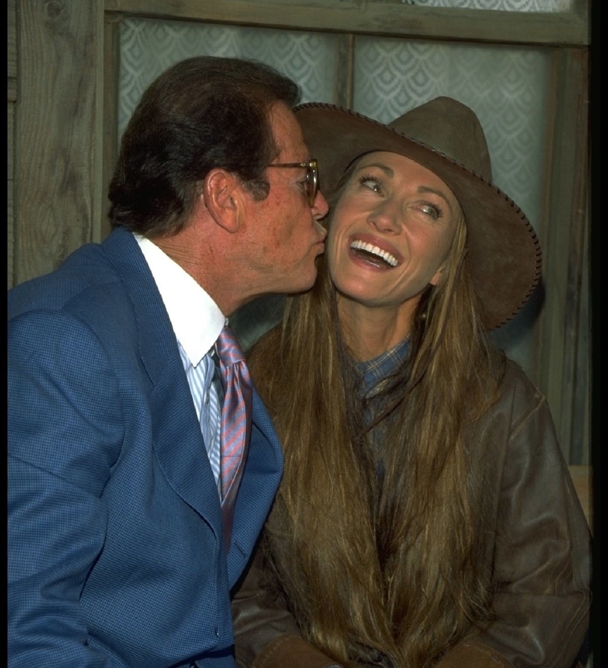 Roger Moore giving Jane Seymour a kiss on the cheek