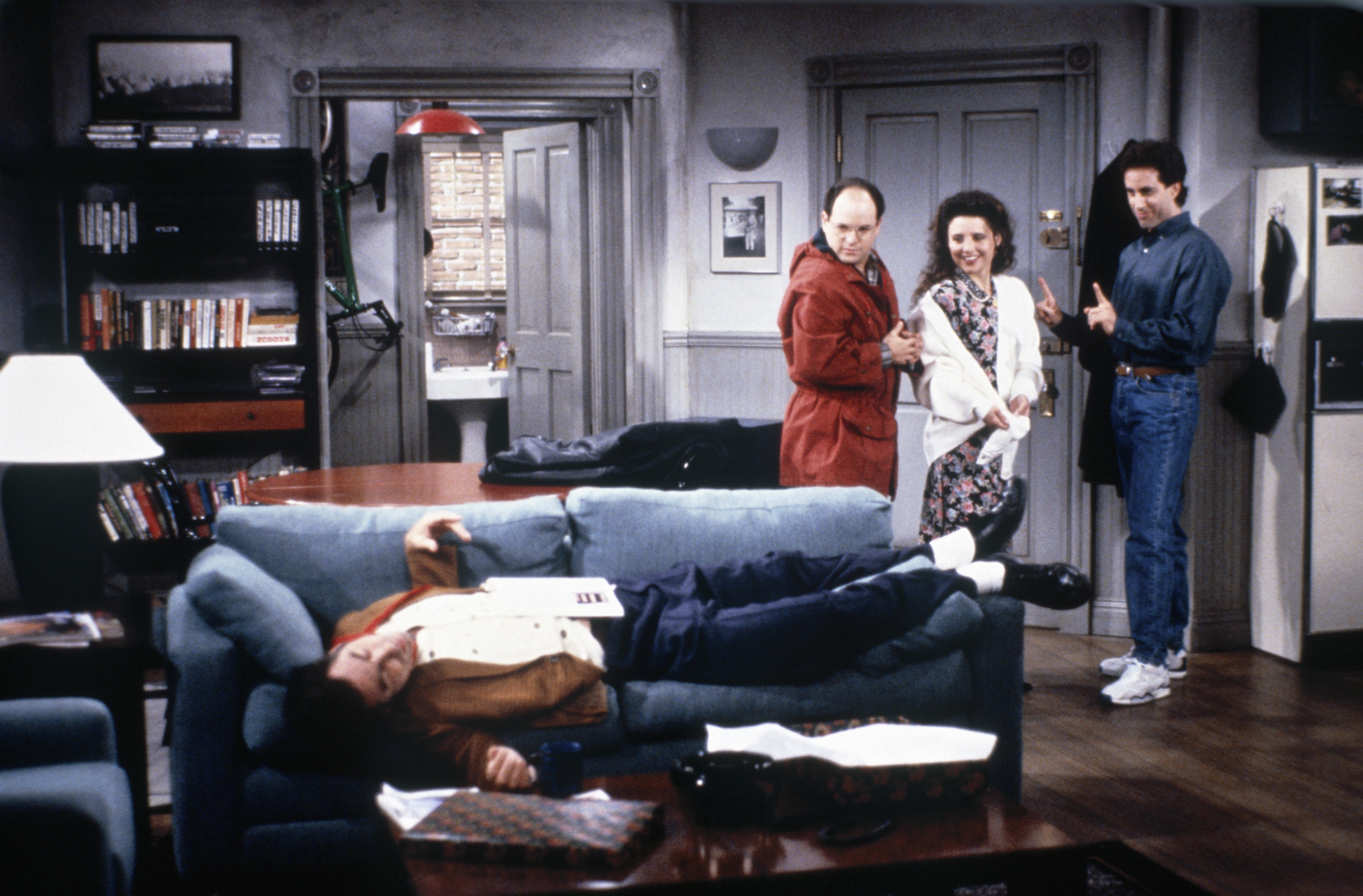 Kramer lays on the couch while George, Elaine and Jerry look on in an episode of 'Seinfeld'. Kramer is similar to several 'Peanuts' characters 