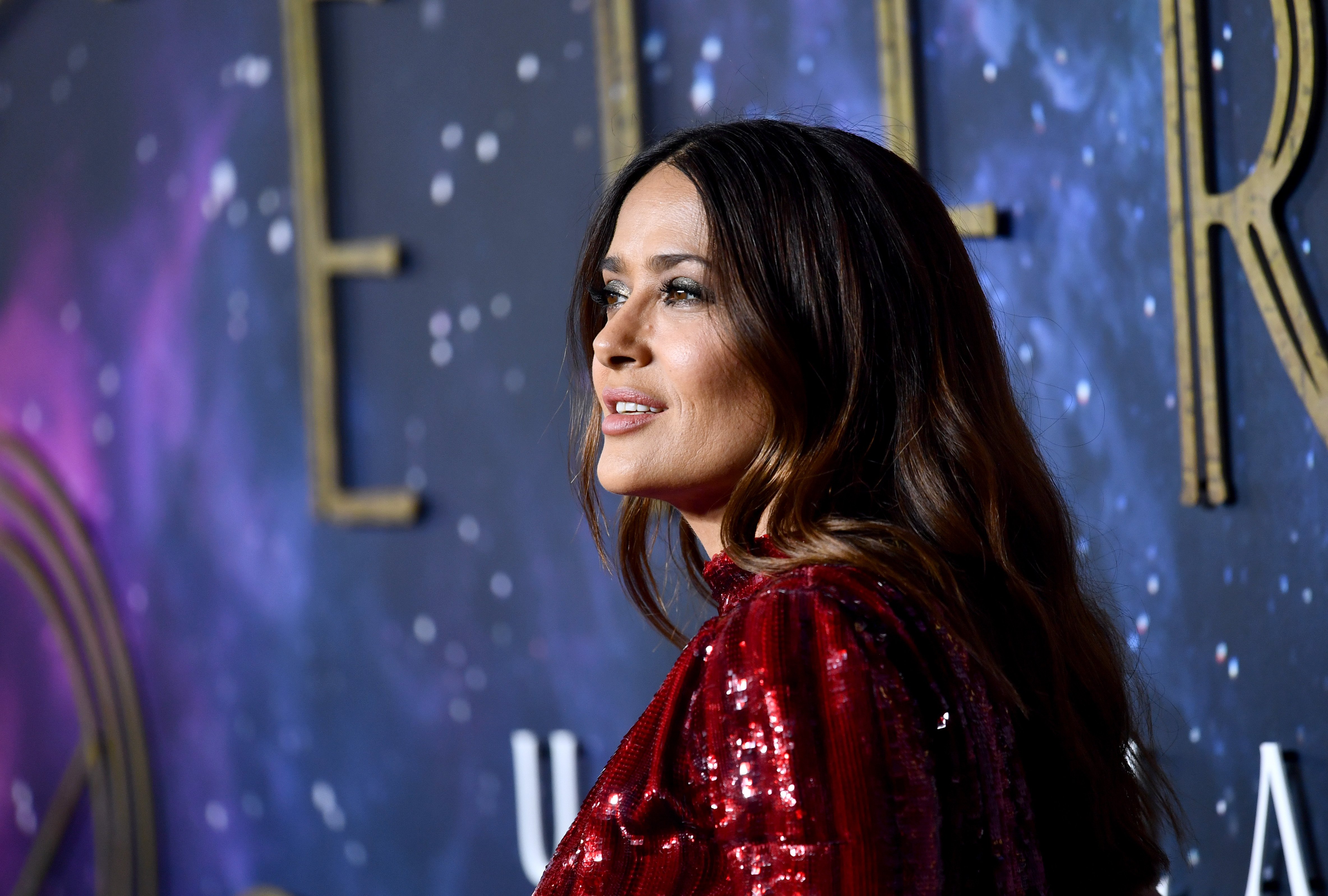 Marvel's 'Eternals' star Salma Hayek wears a dark red sparkly dress.