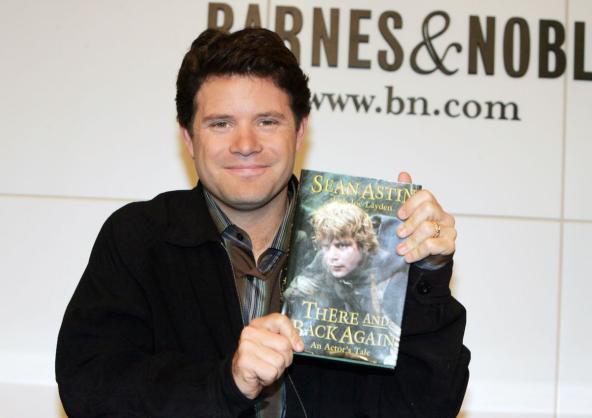 Sean Astin smiles as he poses with a copy of his book ‘There And Back Again: An Actor's Tale - A Behind-The-Scenes Look At Lord Of The Rings’