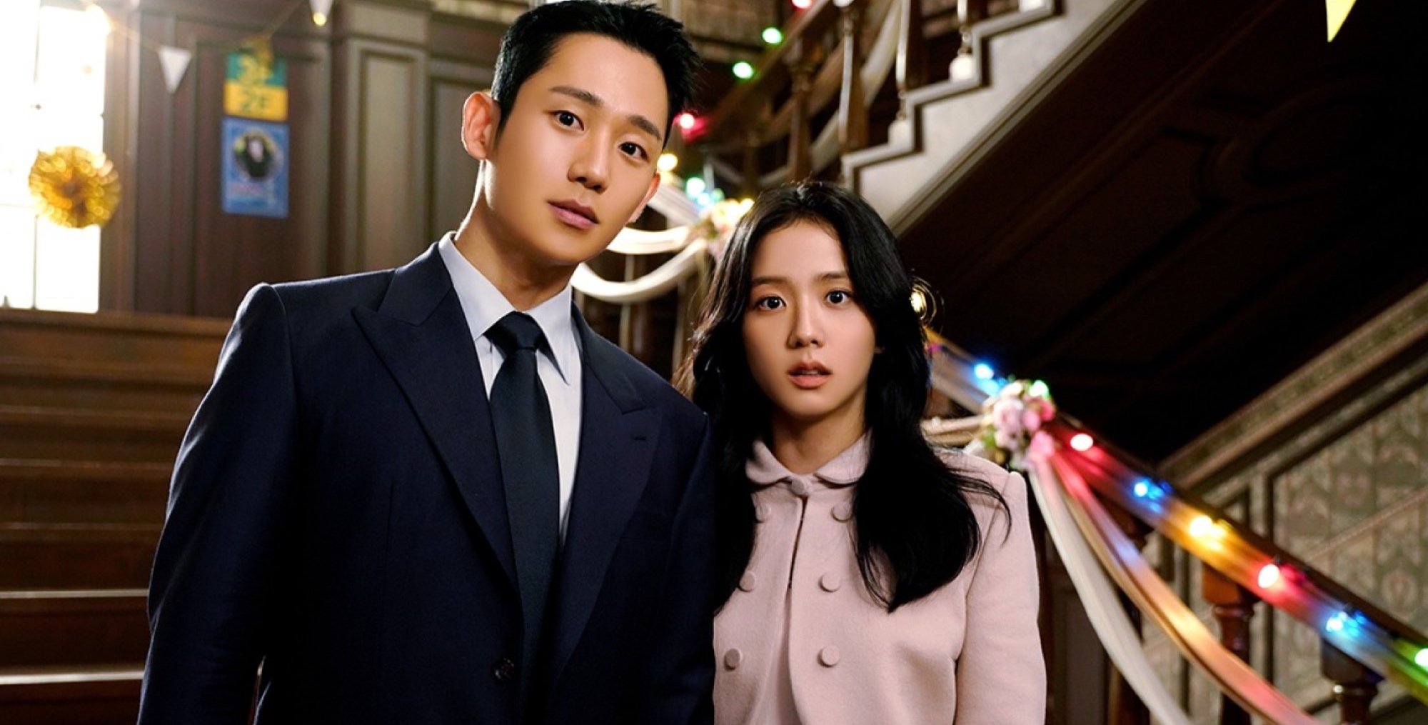 'Snowdrop' characters Soo-ho and Young-ro in North-South Korea romance K-drama wearing suit and pink dress.