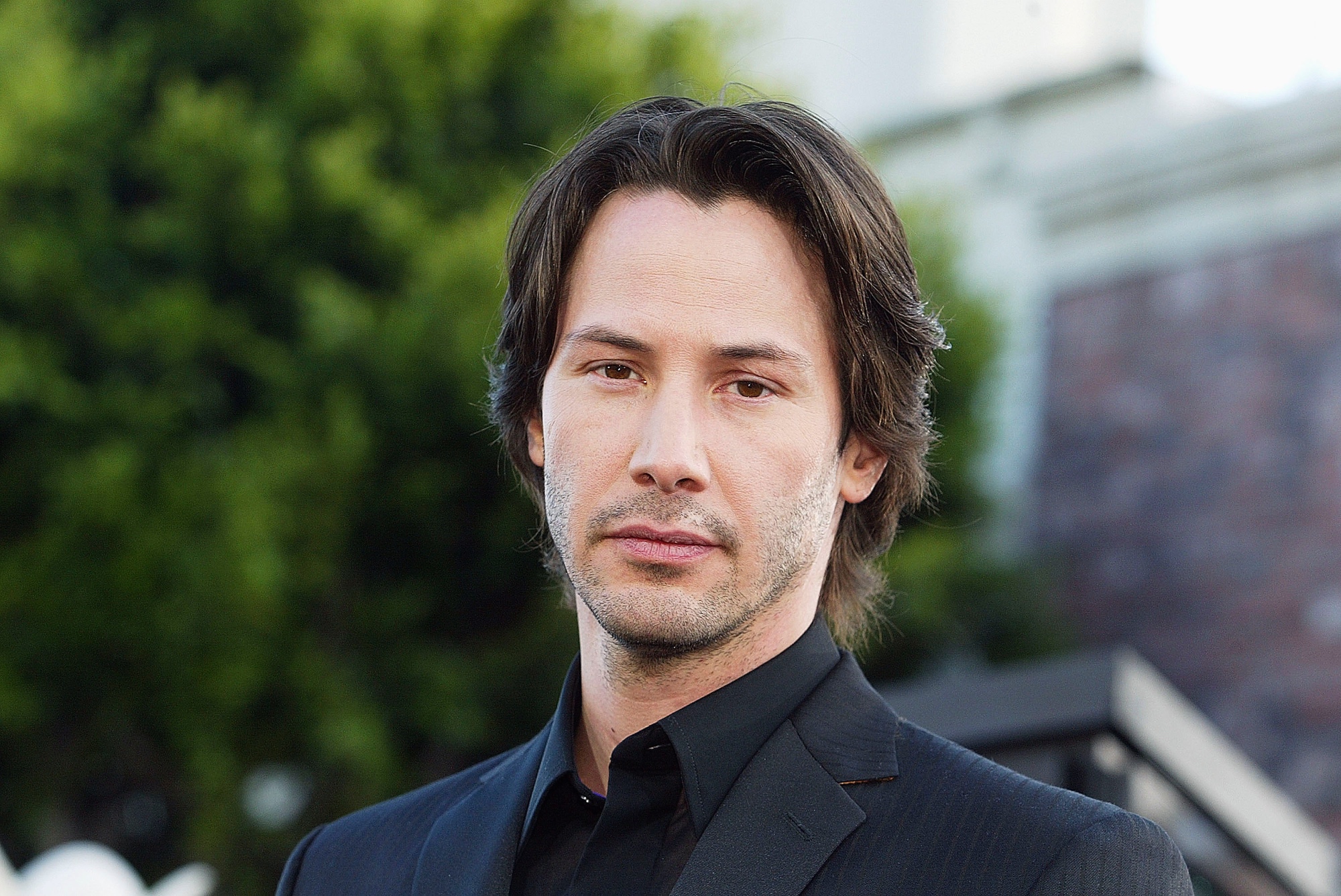 'Speed' star Keanu Reeves wearing a black blazer and dress shirt