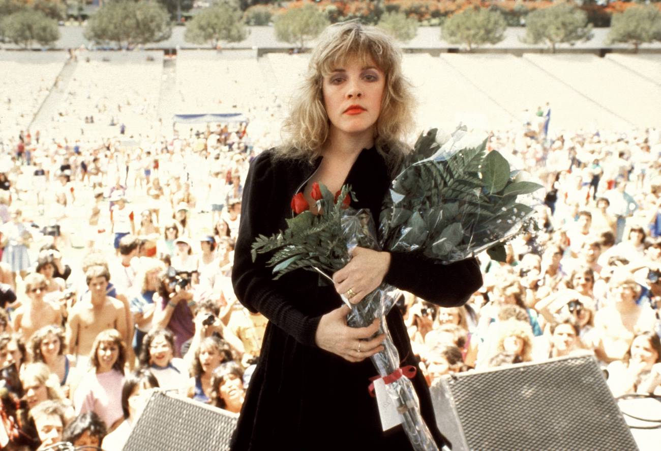 Stevie Nicks holding flowers after a performance at Rock N' Run at UCLA in 1983.