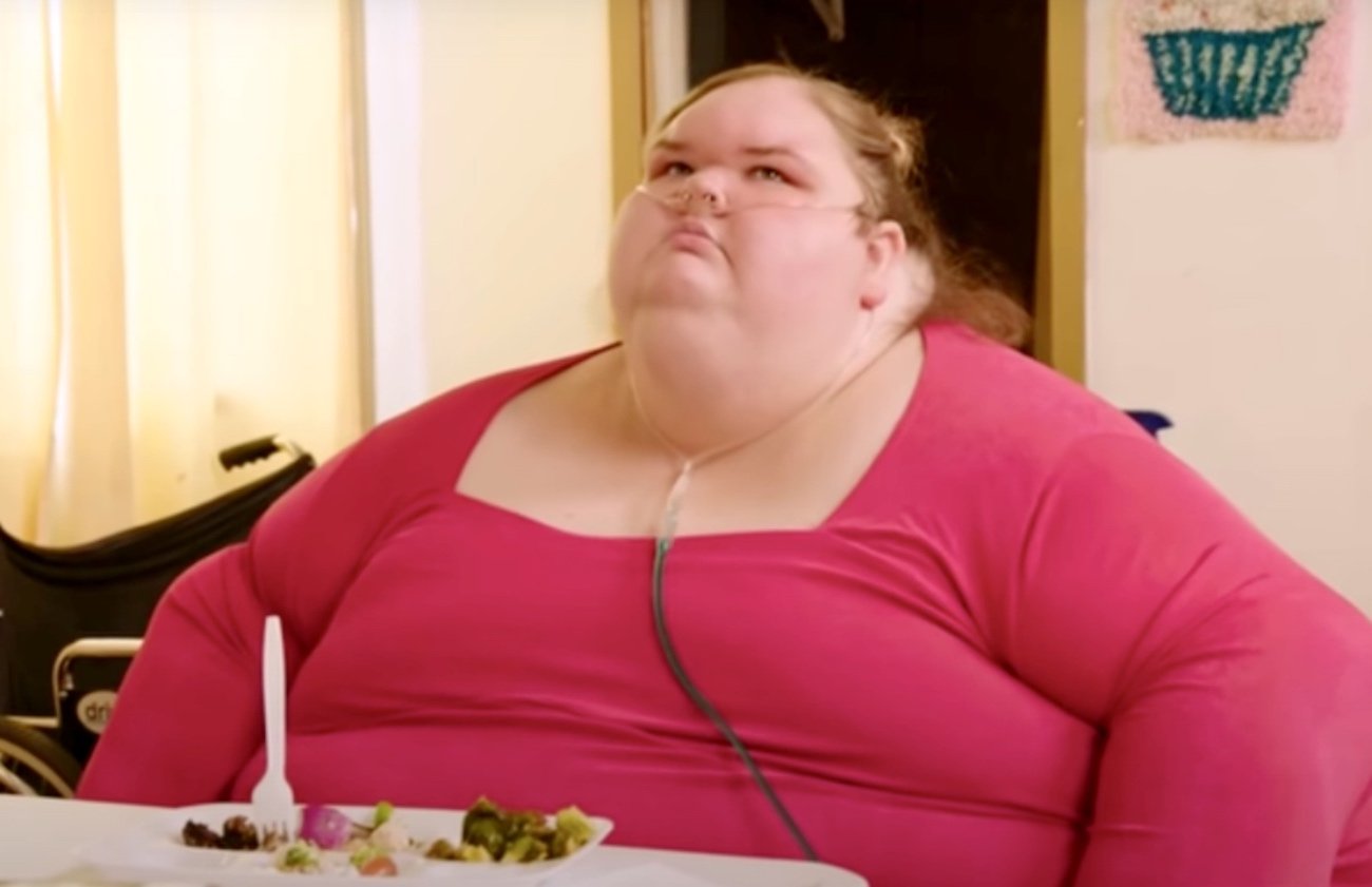 Tammy Slaton sits at a table looking up in an episode of the TLC series '1000-lb Sisters'