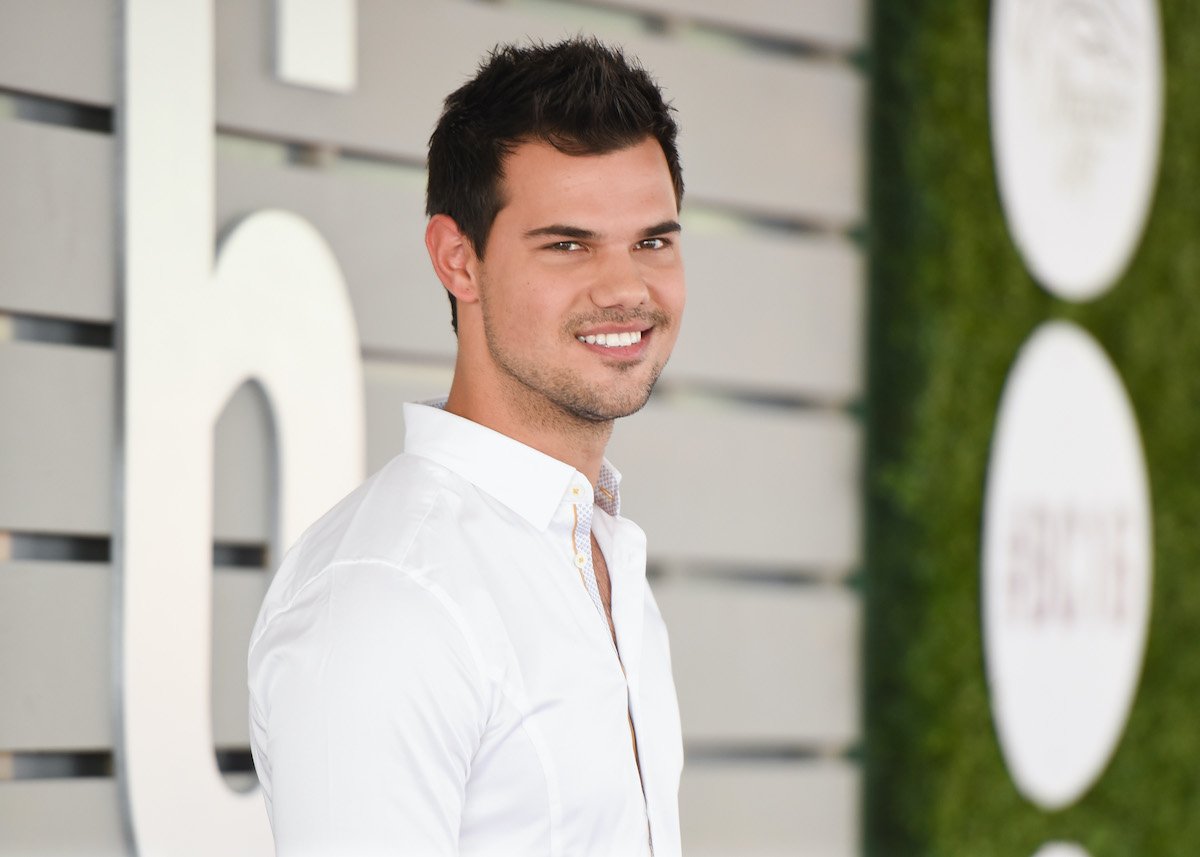 Twilight alum Taylor Lautner smiles in a white shirt