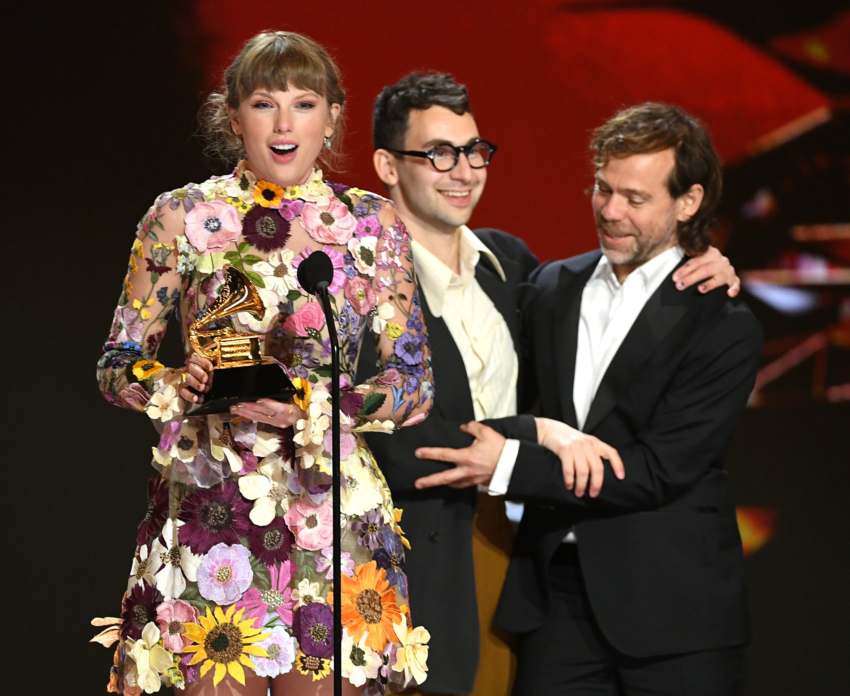 Taylor Swift, Jack Antonoff, and Aaron Dessner onstage at the 2021 Grammy Awards
