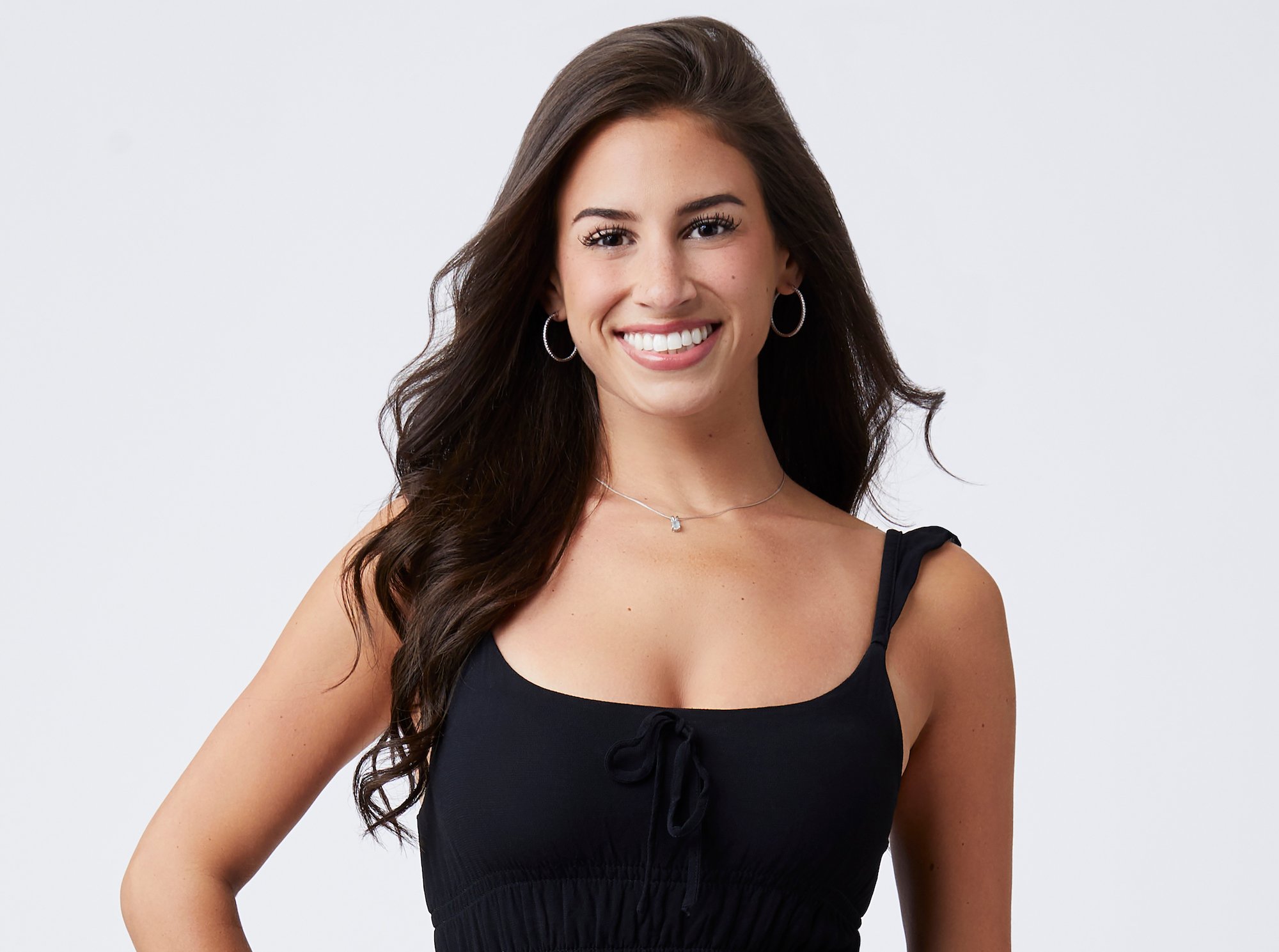 'The Bachelor' 2022 contestant Genevieve Parisi wearing a black sleeveless top in a promotional image for the show.