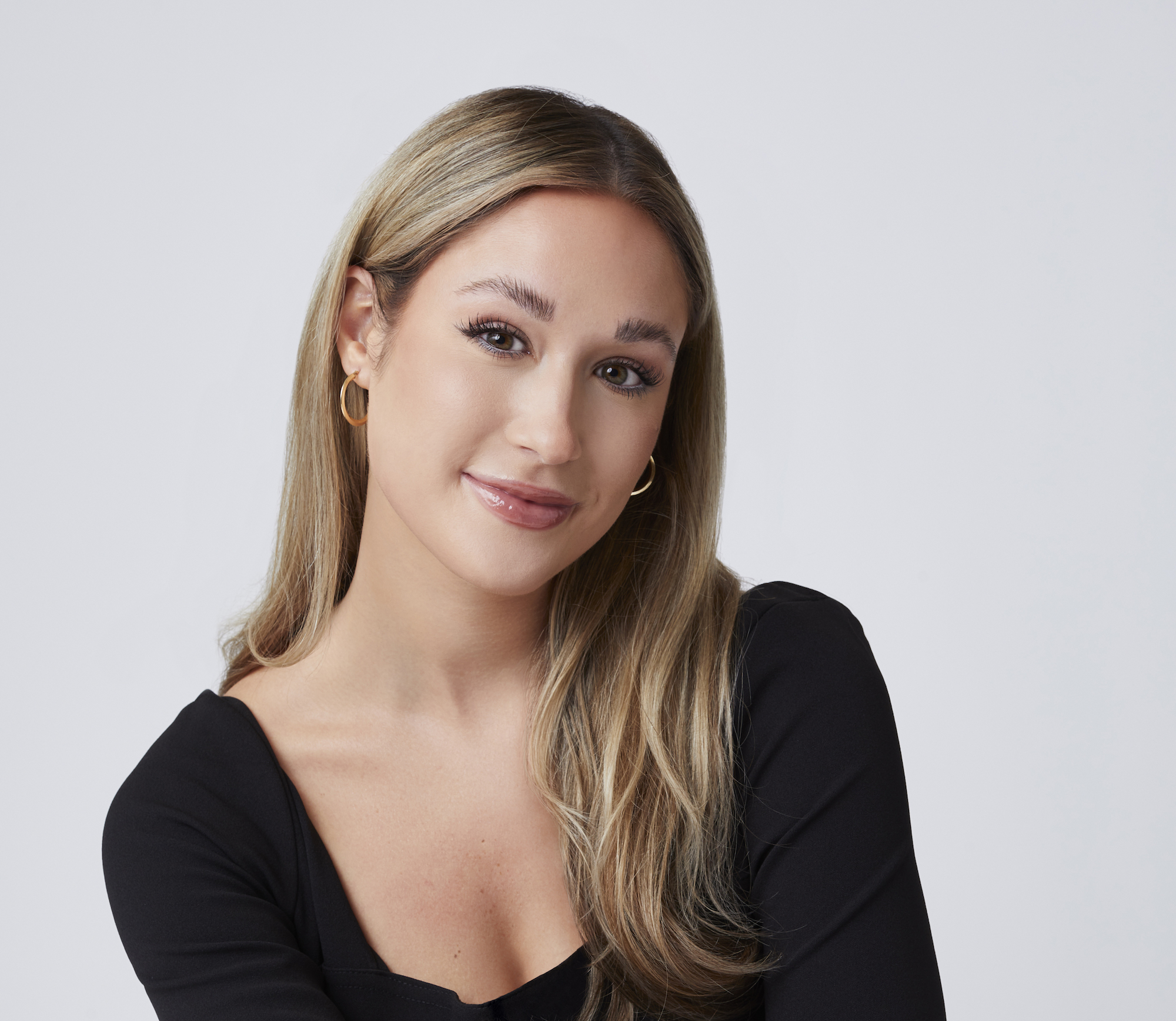 'The Bachelor' 2022 contestant Rachel Recchia wearing a long sleeved black shirt in a promotional image for the show.