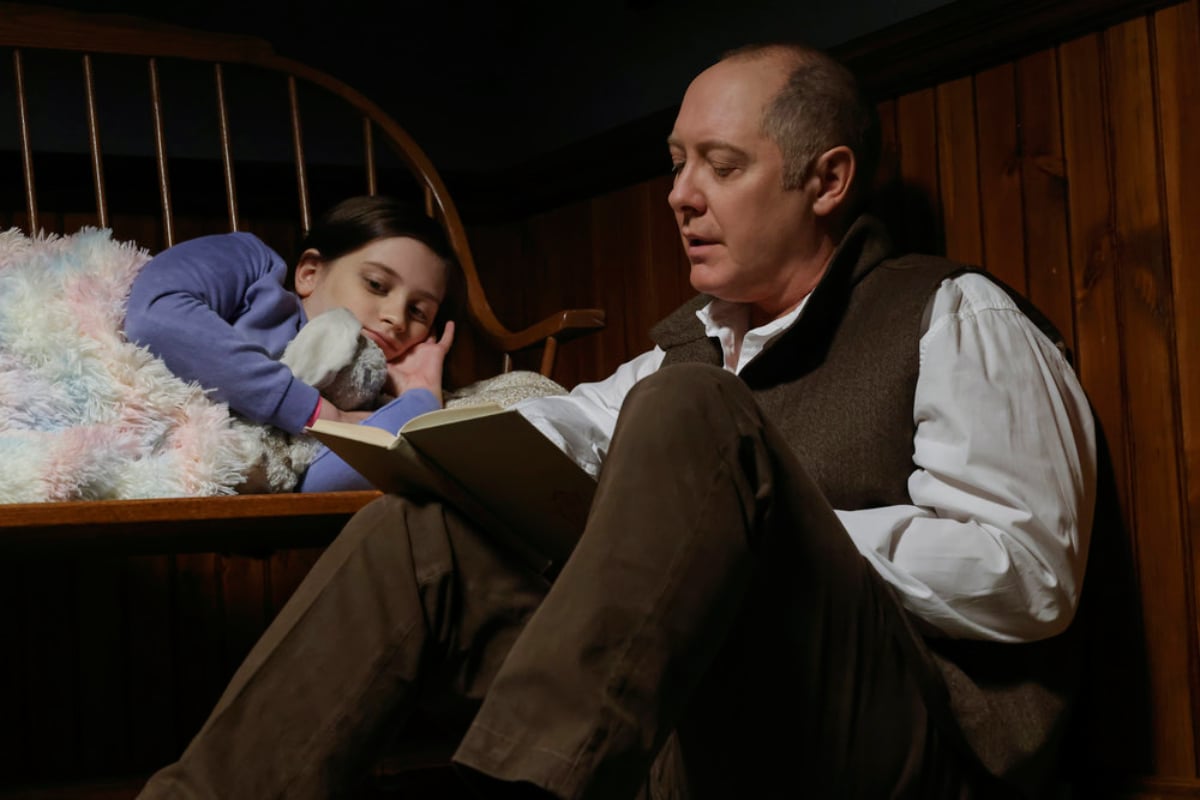 Sami Bray as Agnes and James Spader as Raymond "Red" Reddington in The Blacklist Season 9. Red reads Agnes a story.