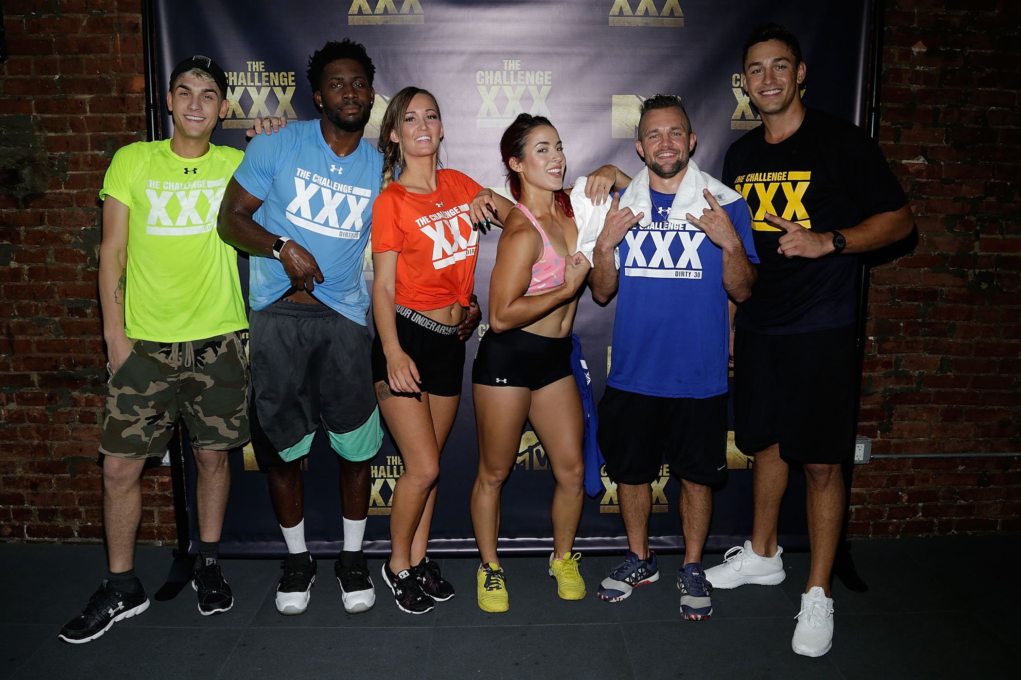 Shane Raines, Derrick Henry, Ashley Mitchell, Cara Maria Sorbello, Derrick Kosinski, and Tony Raines from MTV's 'The Challenge' standing together and smiling