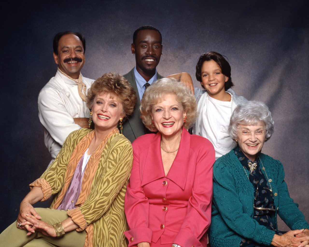 Cheech Marin (as Chuy Castillos), Rue McClanahan (as Blanche Devereaux), Don Cheadle (as Roland Wilson), Betty White (as Rose Nylund), Billy L. Sullivan (as Oliver Webb), Estelle Getty (as Sophia Petrillo) of 'The Golden Palace' pose together in front of a grey background.