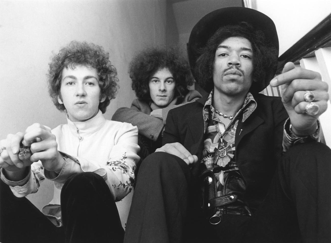 The Jimi Hendrix Experience posing on the stairs wearing 1960s clothes in 1968.