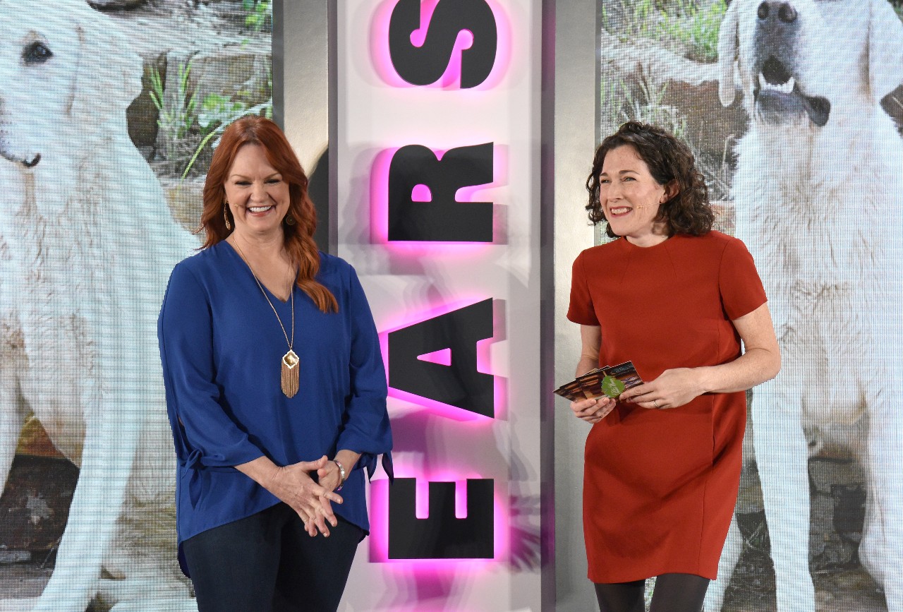 Ree Drummond and Maile Carpenter laugh while presenting a segment for a Pioneer Woman Event