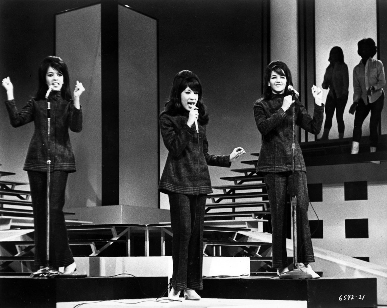 The Ronettes, Estelle Bennett, Ronnie Spector, and Nedra Talley Ross, performing in black on a TV show in 1965.